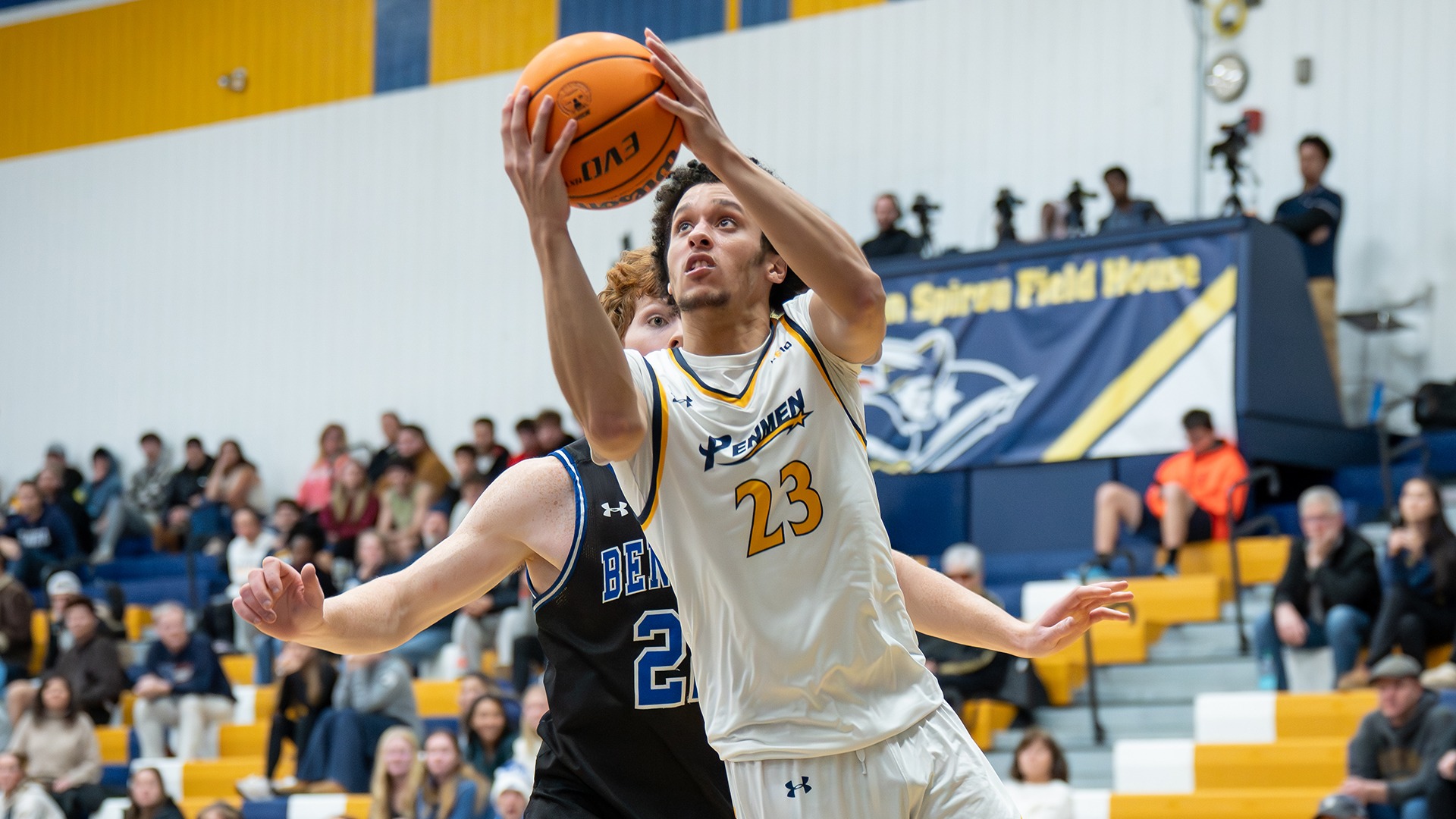 Jojo Wallace driving for a layup with a defender in the background