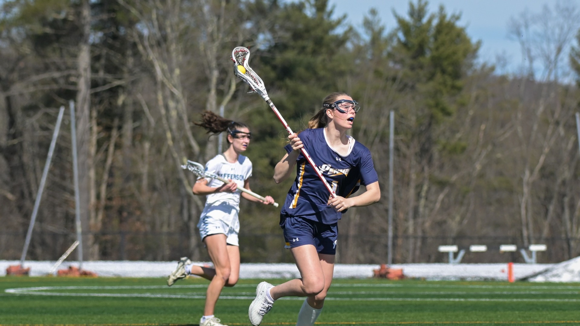 Piper Knowlton carries the ball for SNHU women's lacrosse