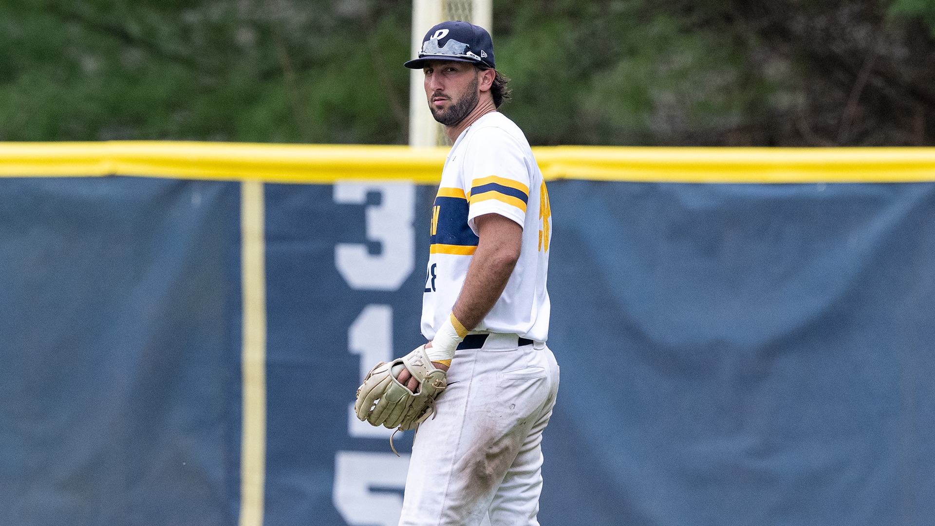 Jake Pisano standing in the outfield with his glove
