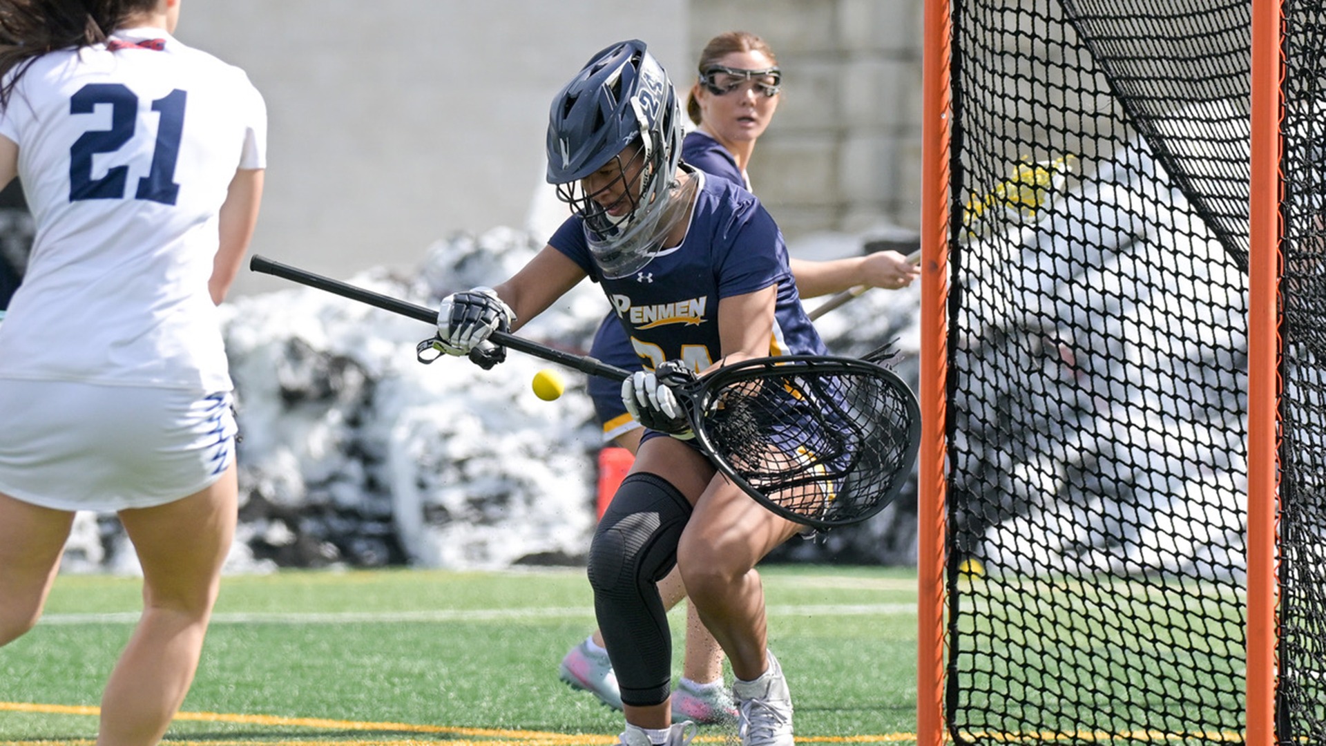 Corrina Moulton making a save in front of the goal with an opponent in the foreground