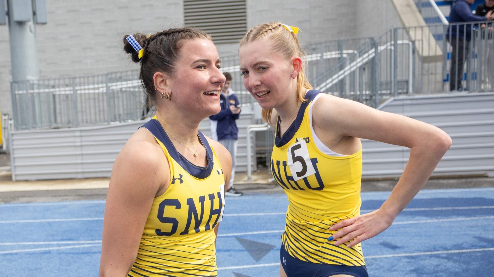 SNHU runners Erika Wojcik and Deirdre Baillat smile after a racde