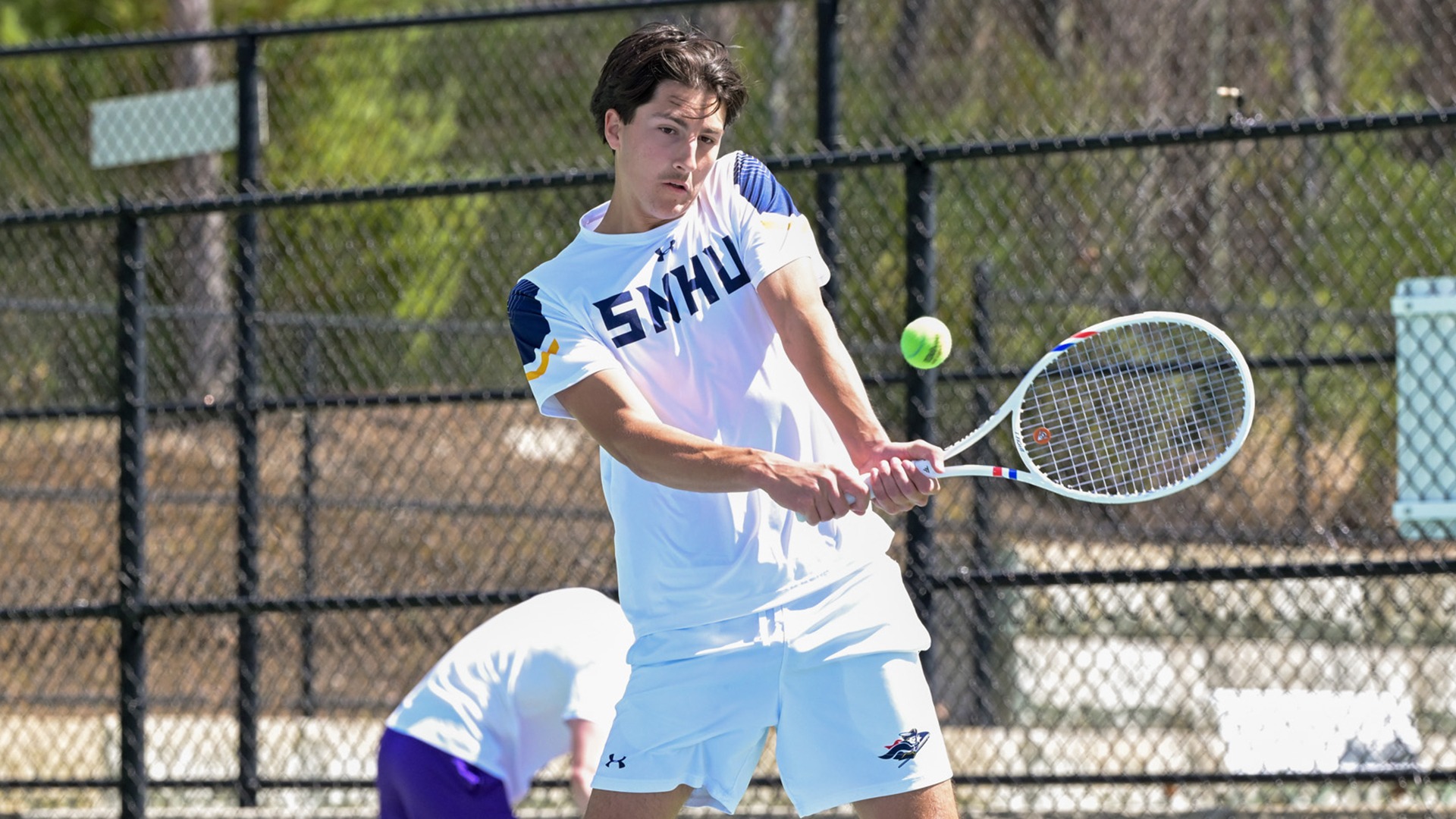 Aurel Creveuil hitting a backhand shot