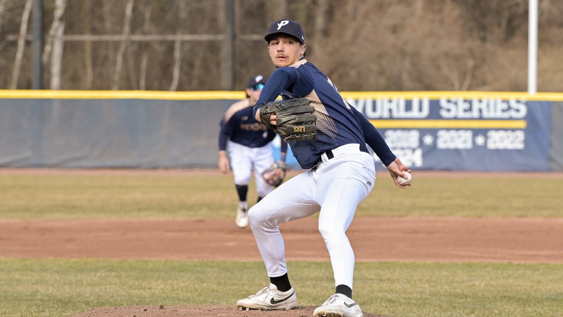 Zak Whitney winds up to deliver a pitch for SNHU baseball