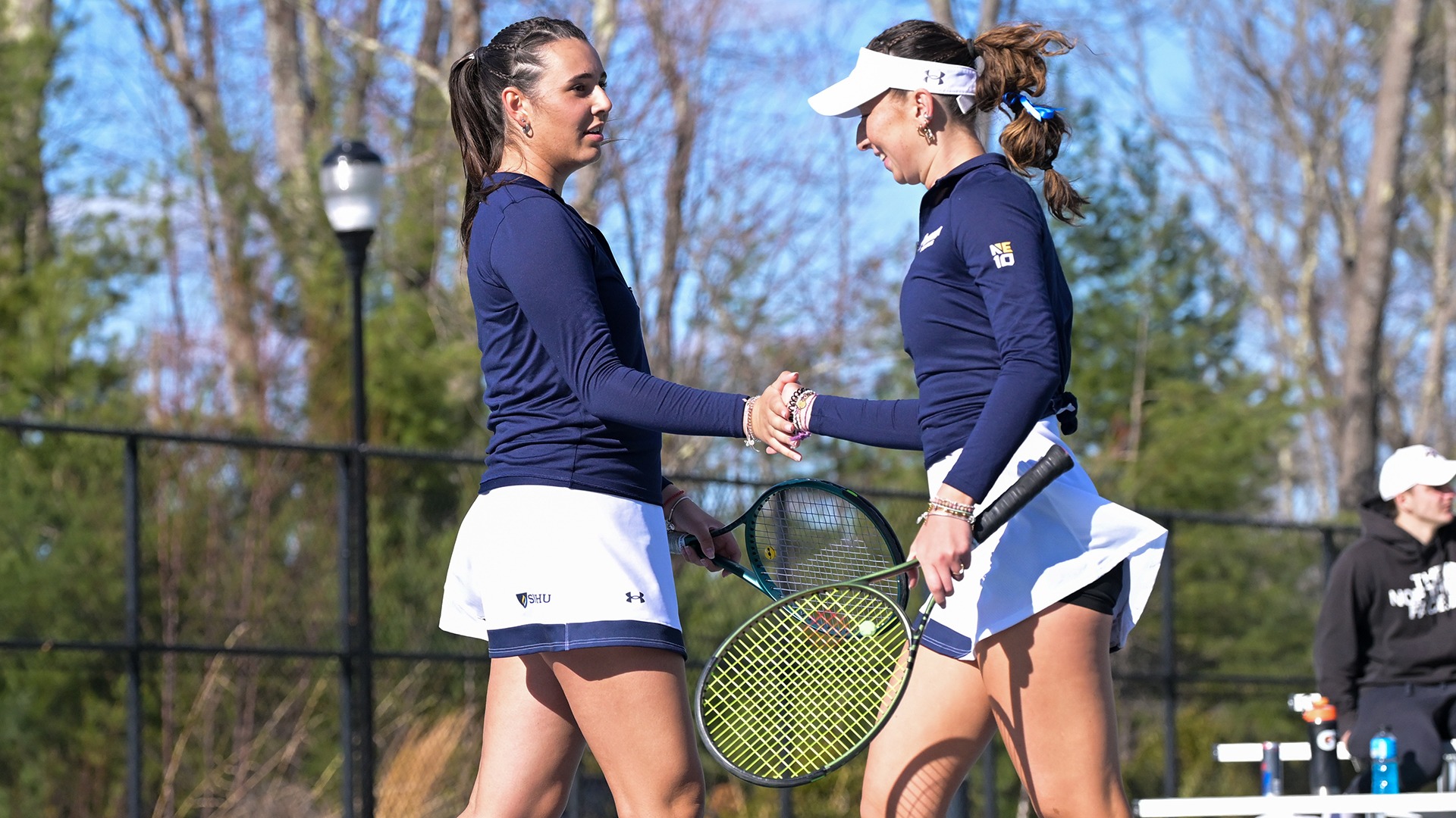 Dajana Abadzic and Lois Tsui slapping hands after winning a point