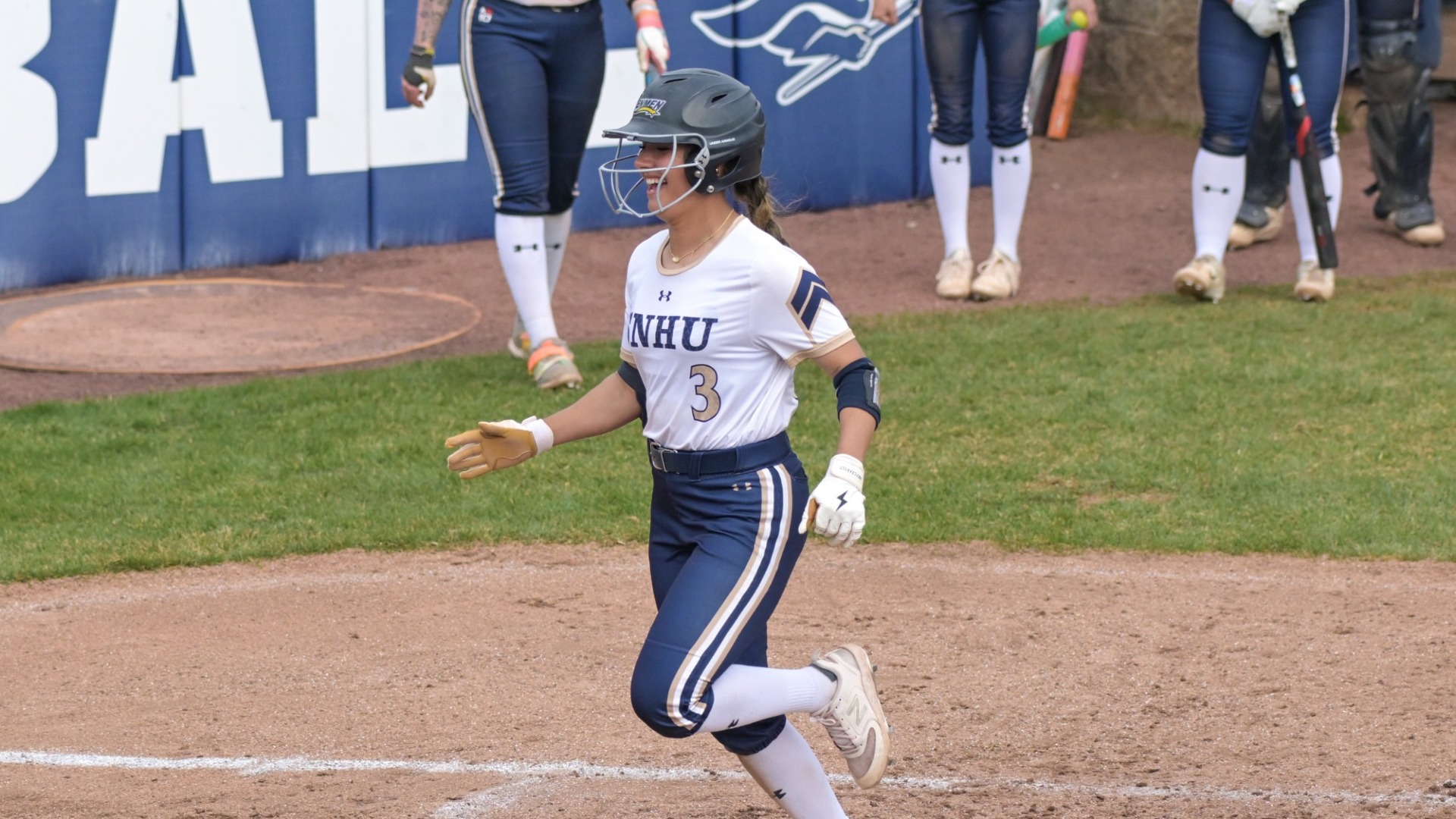 Mikaya Alto of softball is all smiles as she scores a run for the Penmen
