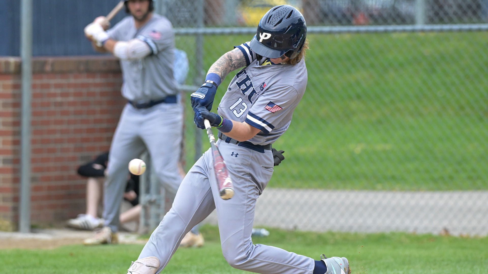 Dakota Britt mid-swing with the baseball nearing his bat