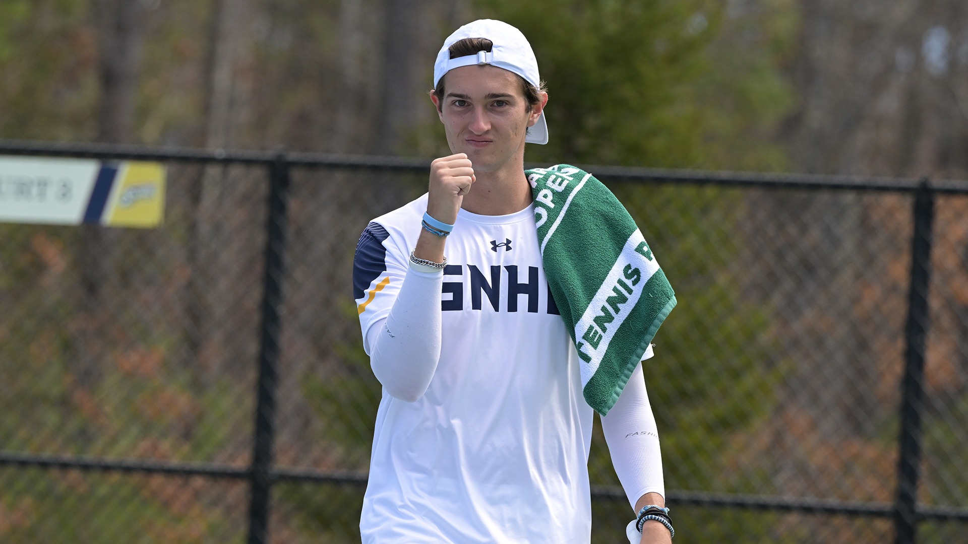 Carlos Molero pumps his fist with a towel draped over his shoulder