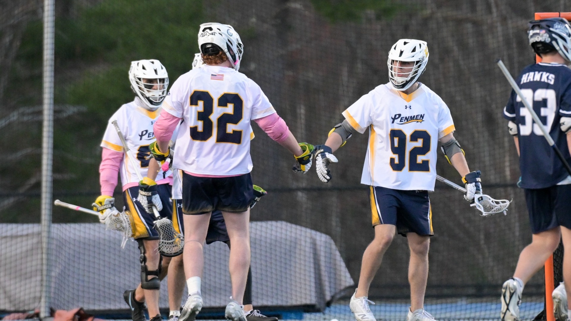 PJ Cunningham of men's lacrosse celebrates with teammate Aiden Blouin 