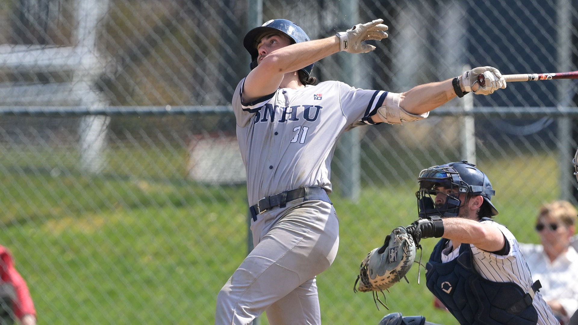 Casey Cumiskey swinging at a pitch with the catcher in the background