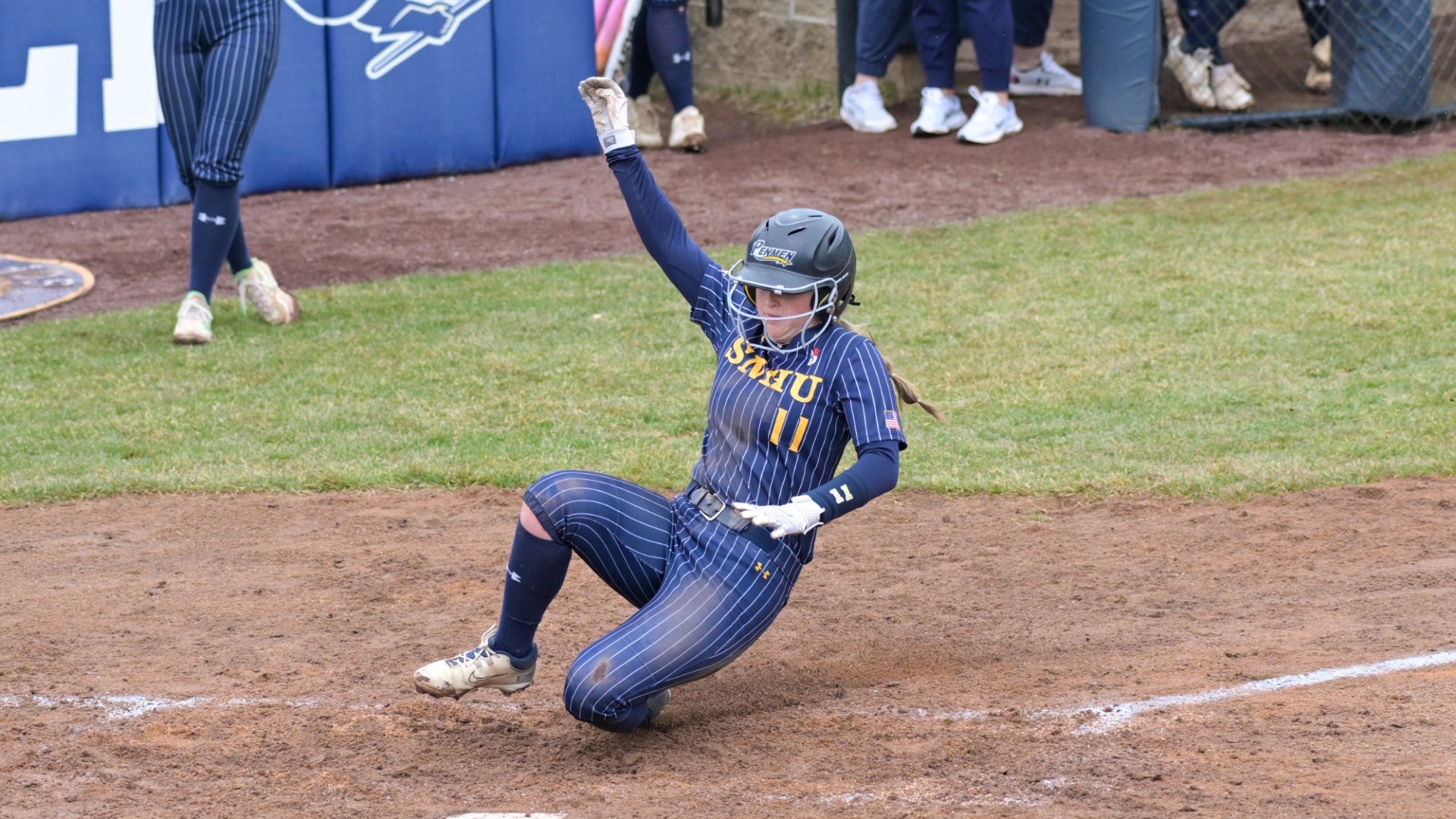 Alyssa Abbott slides into home plate to score a run for the SNHU softball team