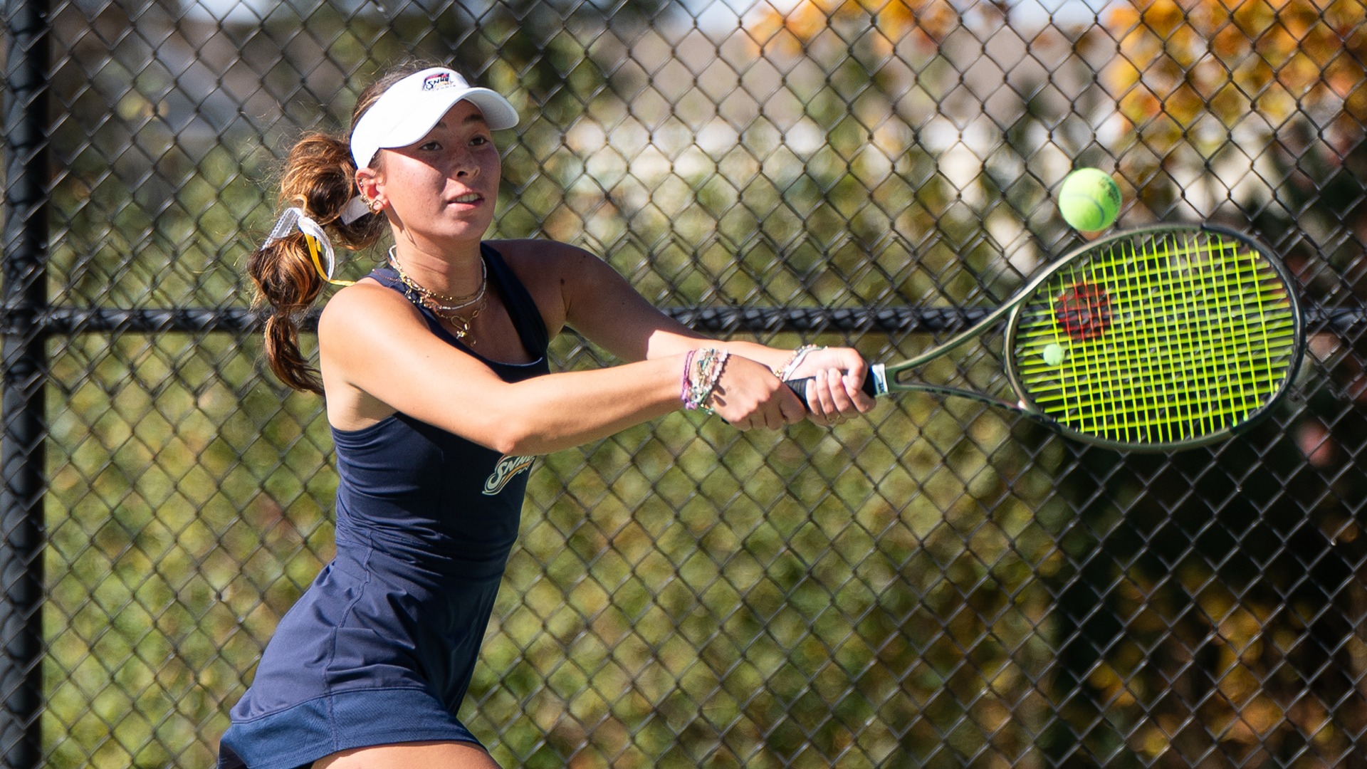 Lois Tsui hitting a backhand shot