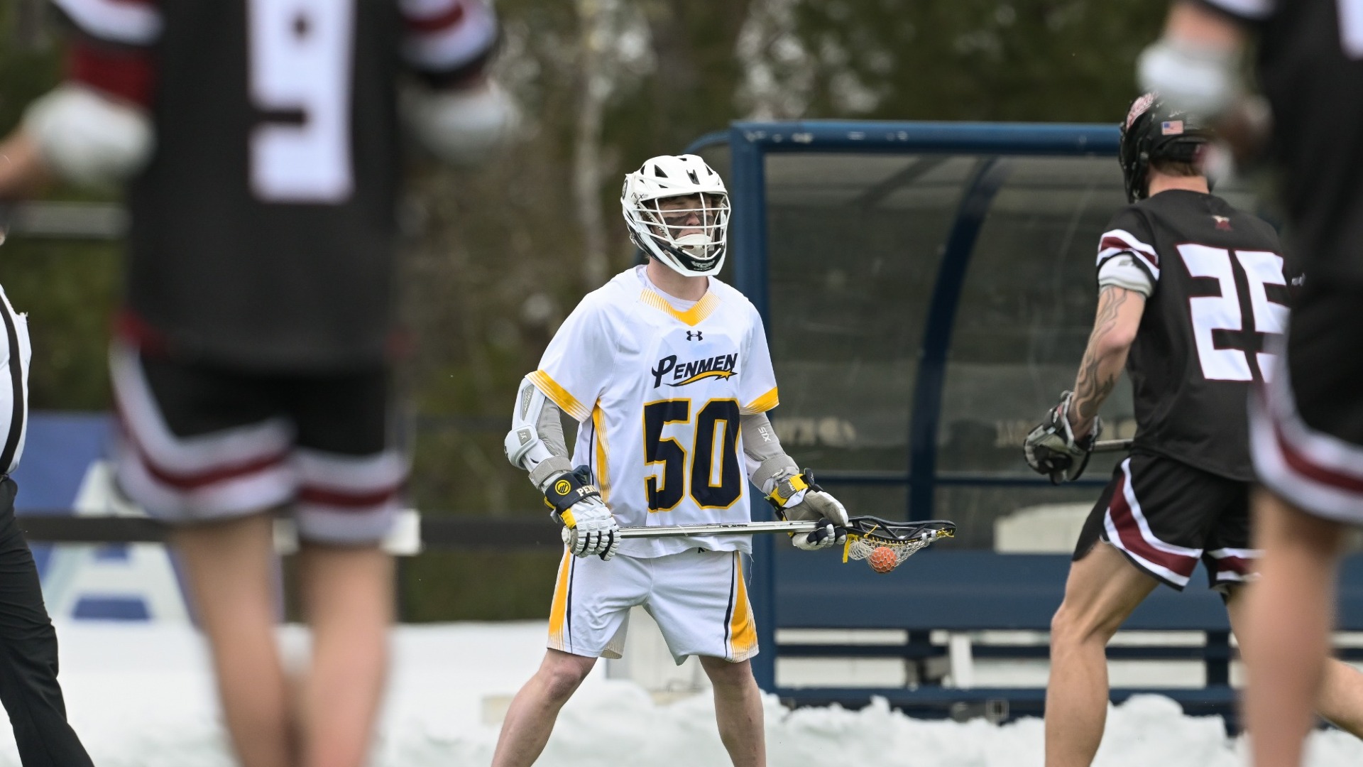 Blake Wozniak of men's lacrosse holding his cross 