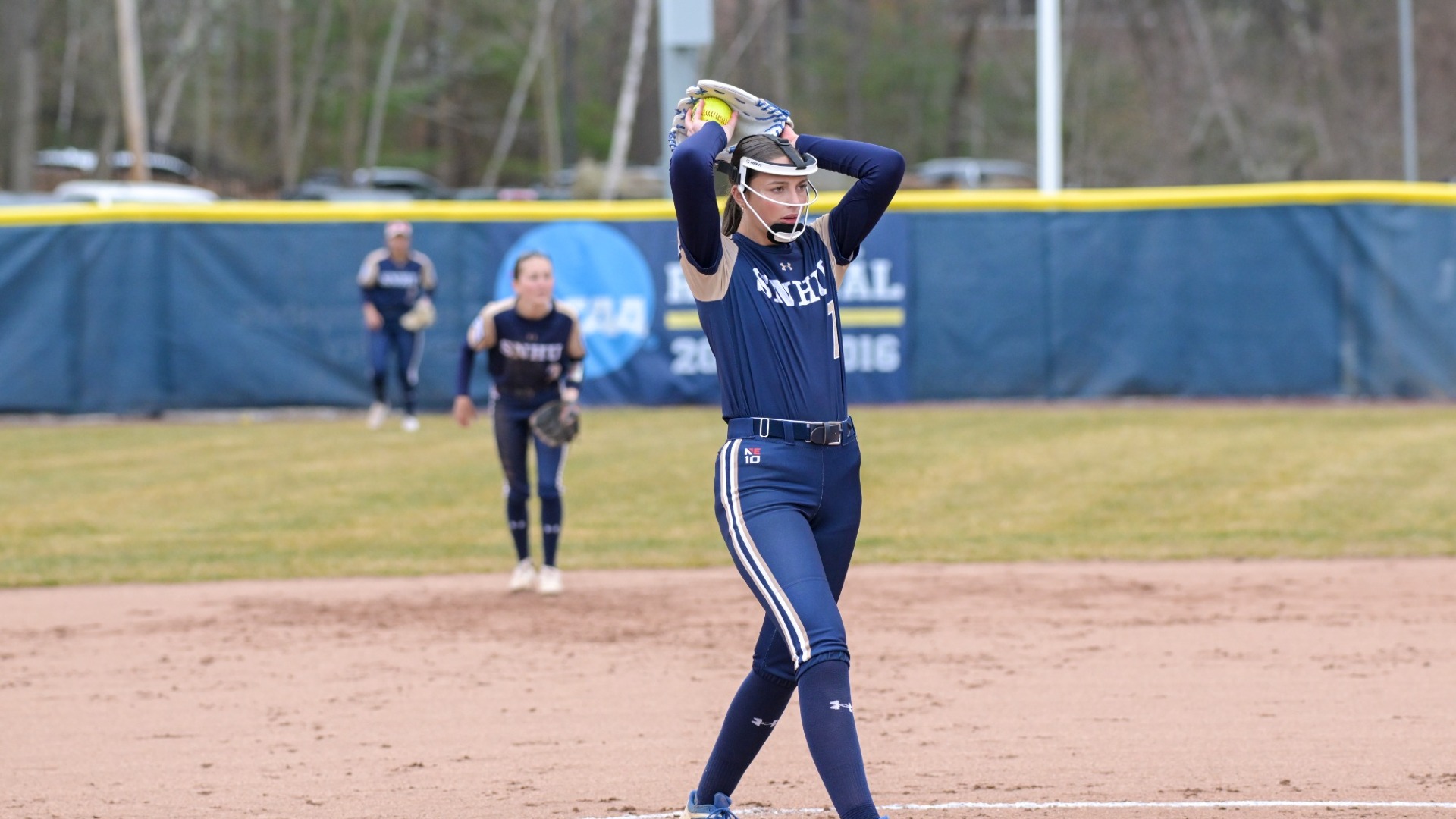 Sophie Roussel of softball winds up as she is about to deliver a pitch