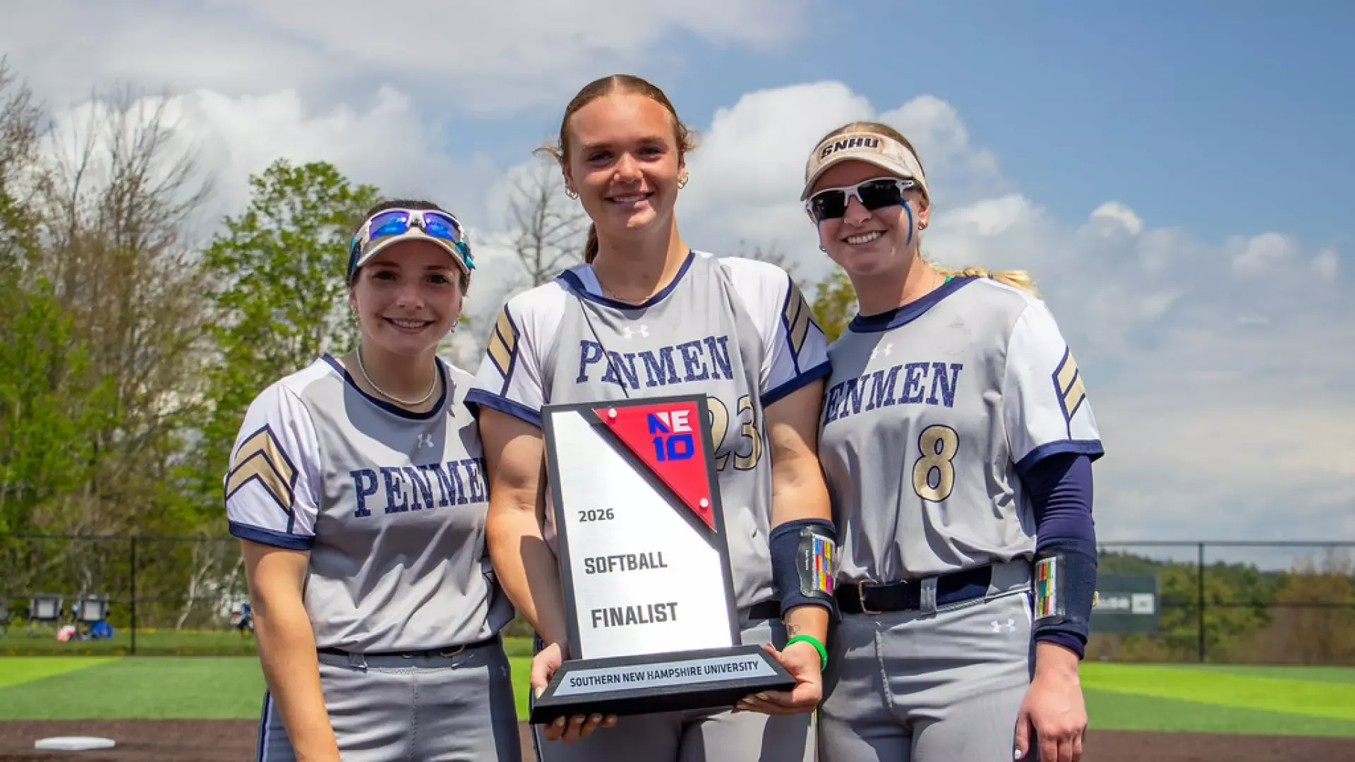 SNHU softball captains Peyton Feldman, Abby Lineman, and Sid Rose accept the consolation plaque