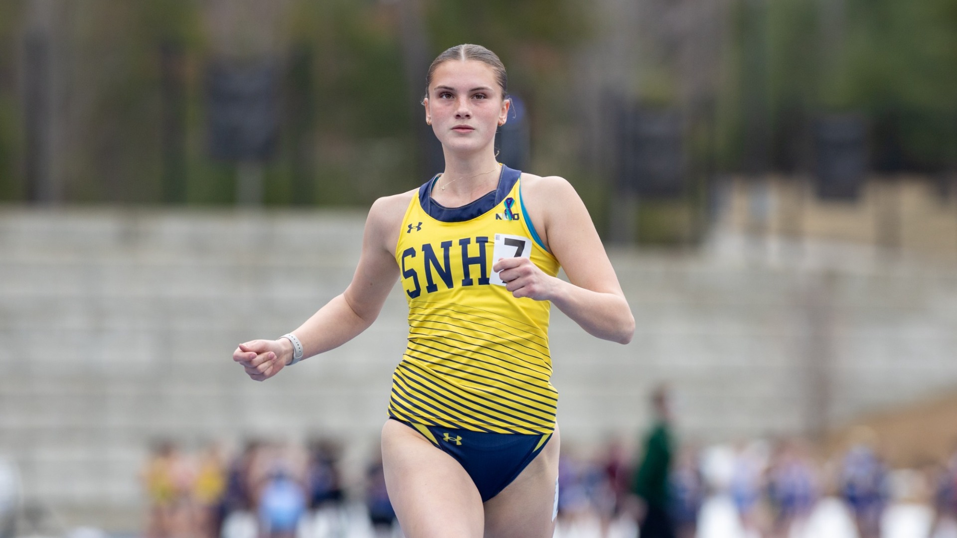 Kay Wheelock finishes a race for SNHU Track & field