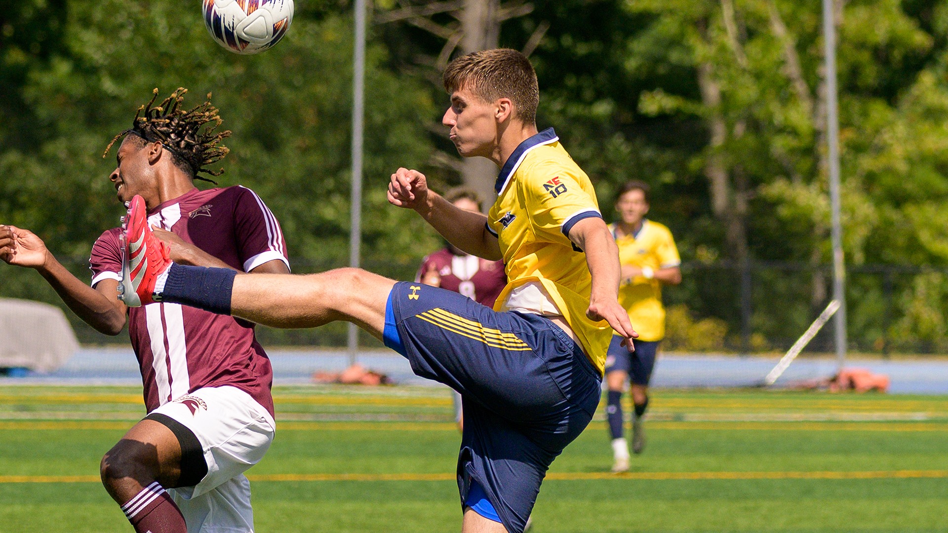 Inigo Iriarte jumping to kick the ball with a defender in the frame