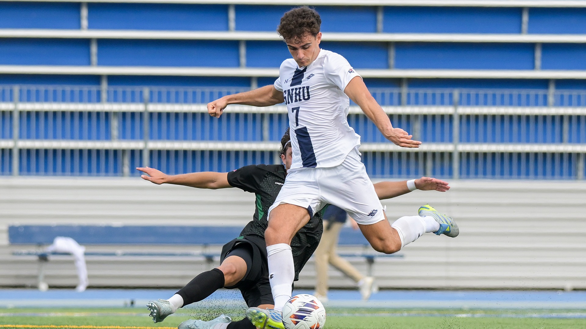 Inigo Burusco shooting the ball with a defender at his feet