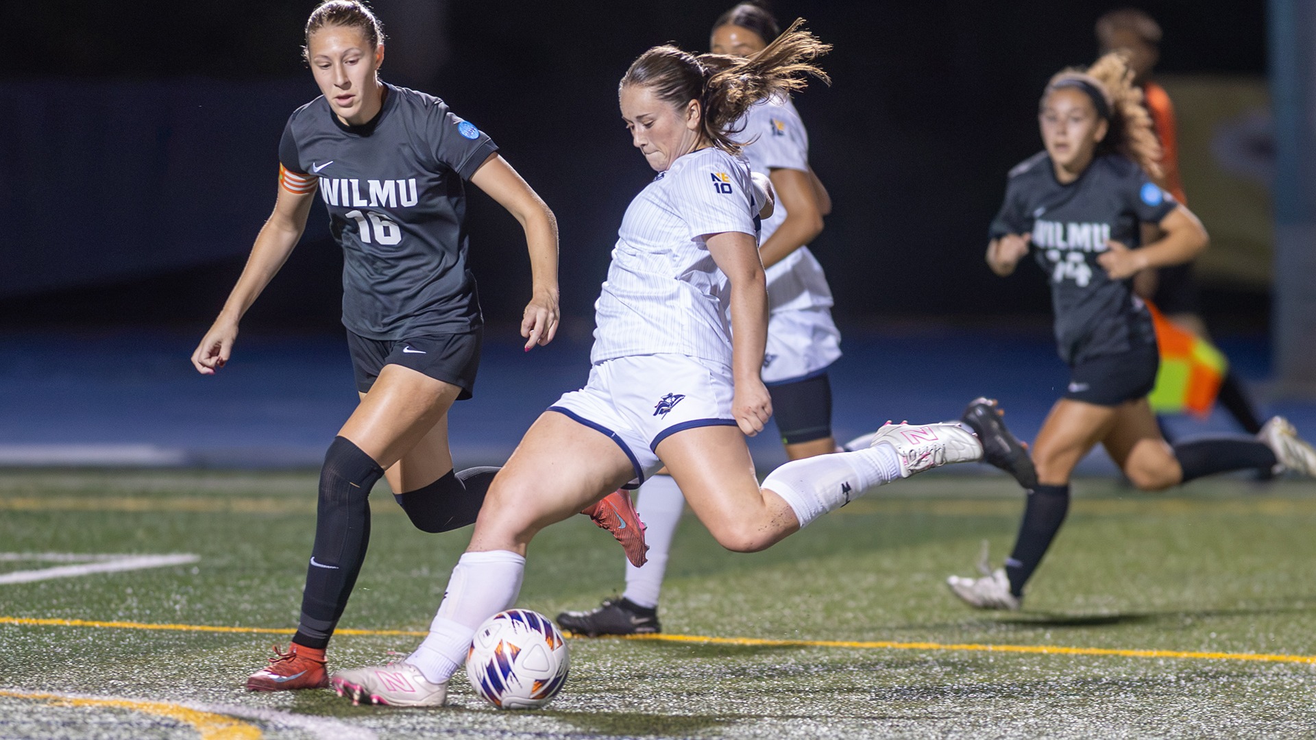 Mollie Cahalane shooting the ball with defenders and a teammate in the background