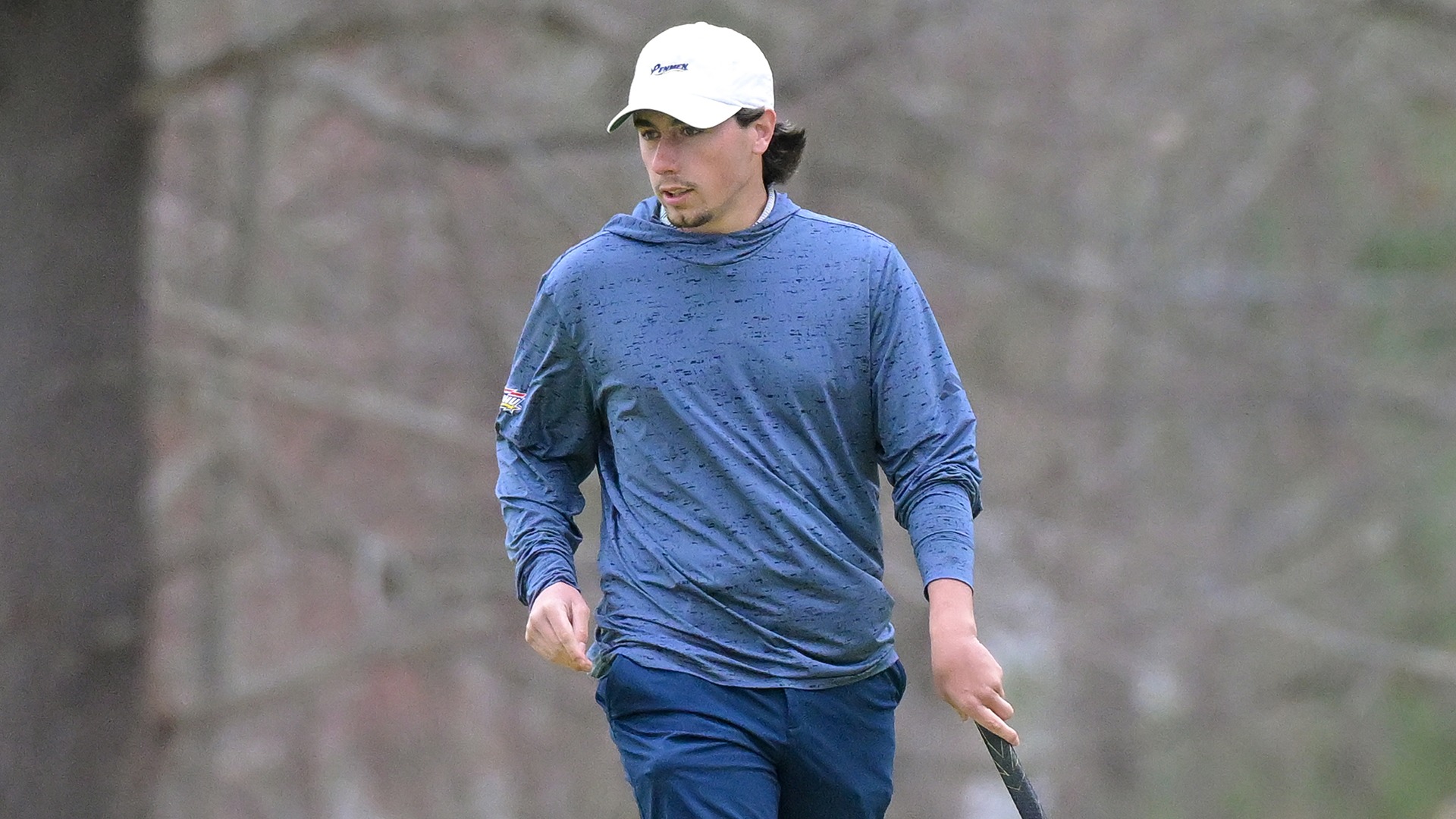 Andrew Surprenant walking on the green with his club