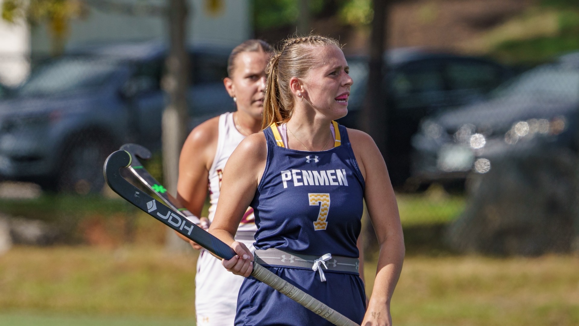 Olivia Andersen of field hockey shown holding her stick with a defender pictured behind her