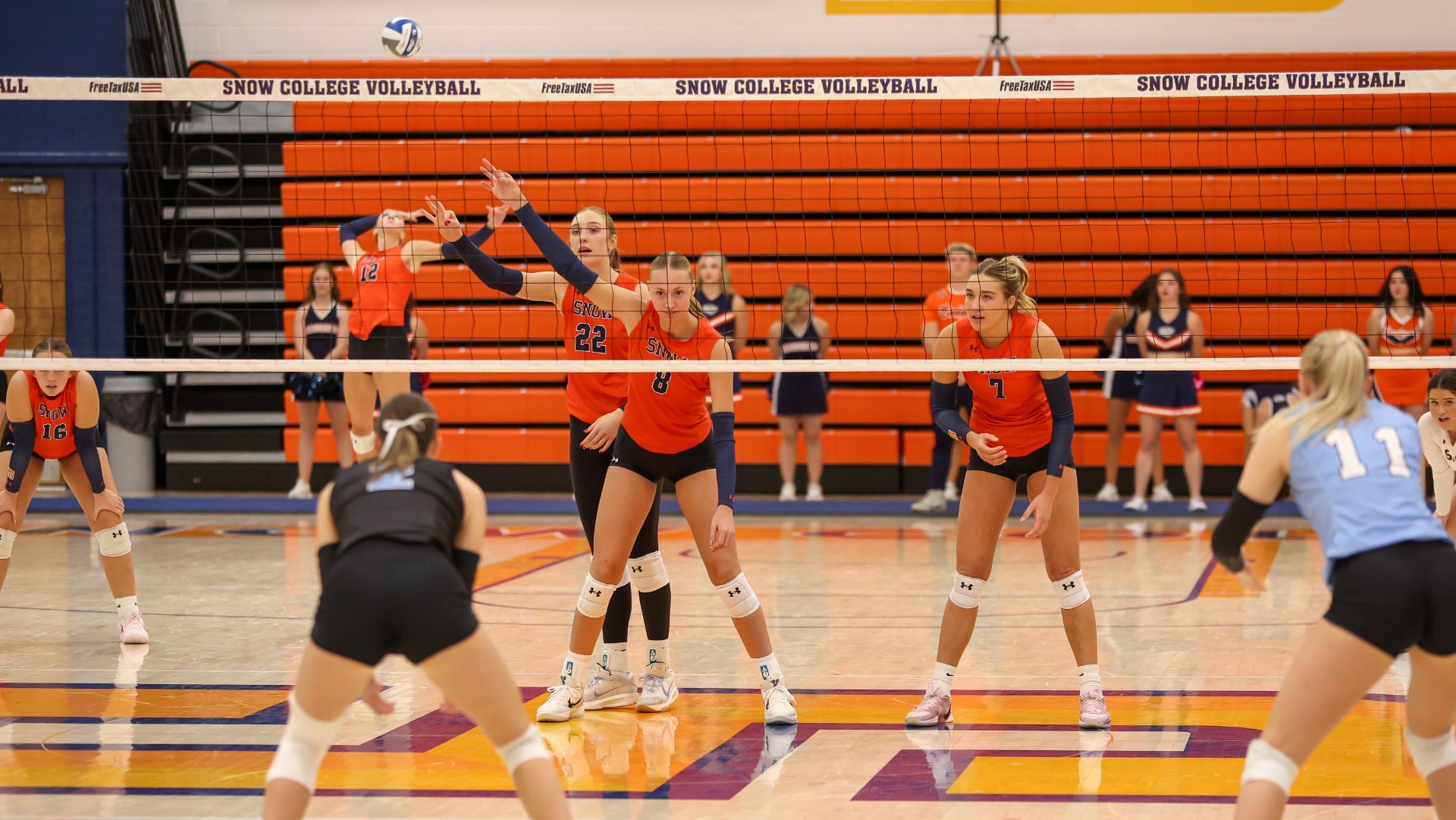 Aleah McDaniel, Justi Cook, and Alli Anthon ready their defense for the serve
