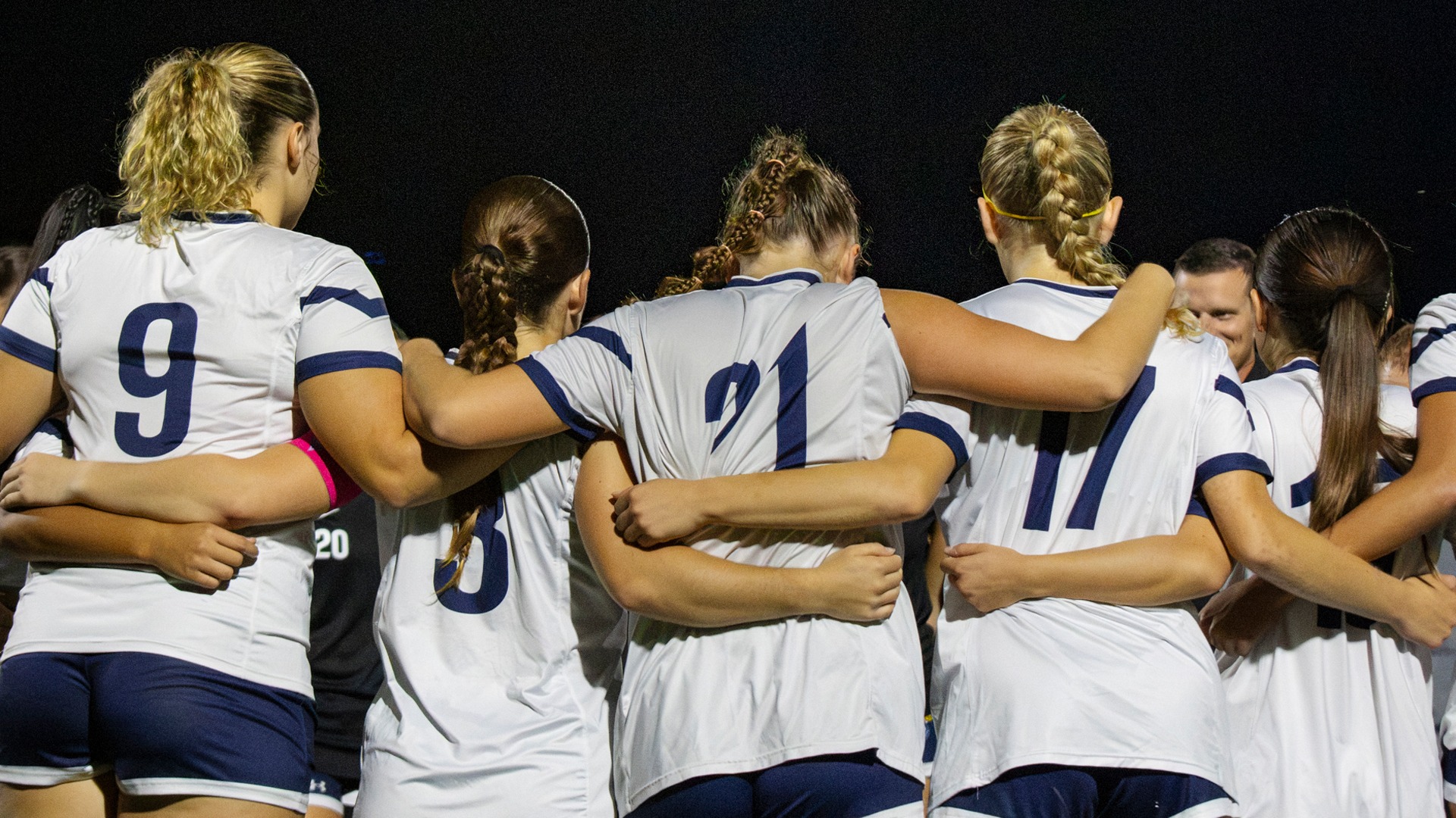 Women's Soccer Team Huddle vs Rivier