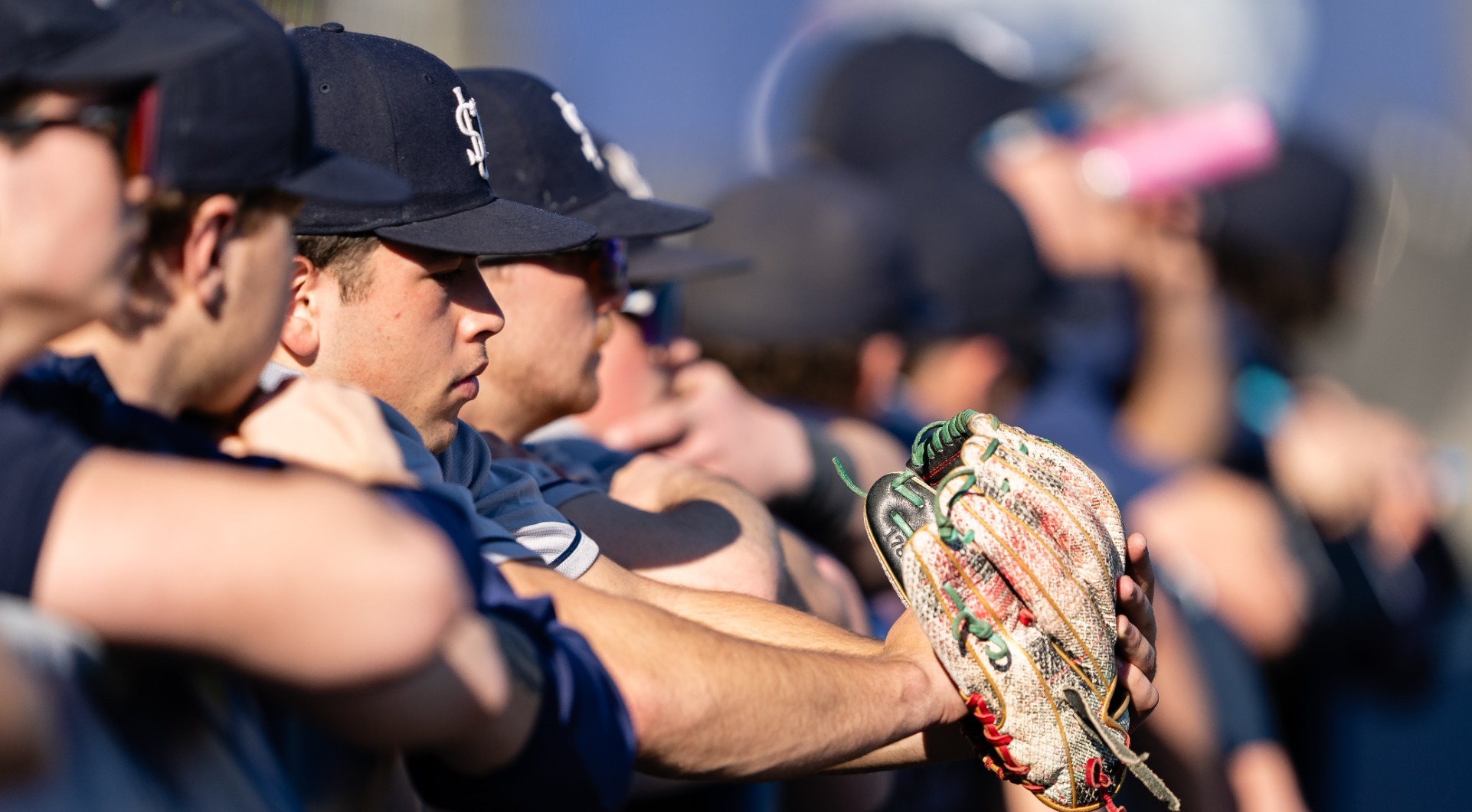 Baseball players at Dugout Fence