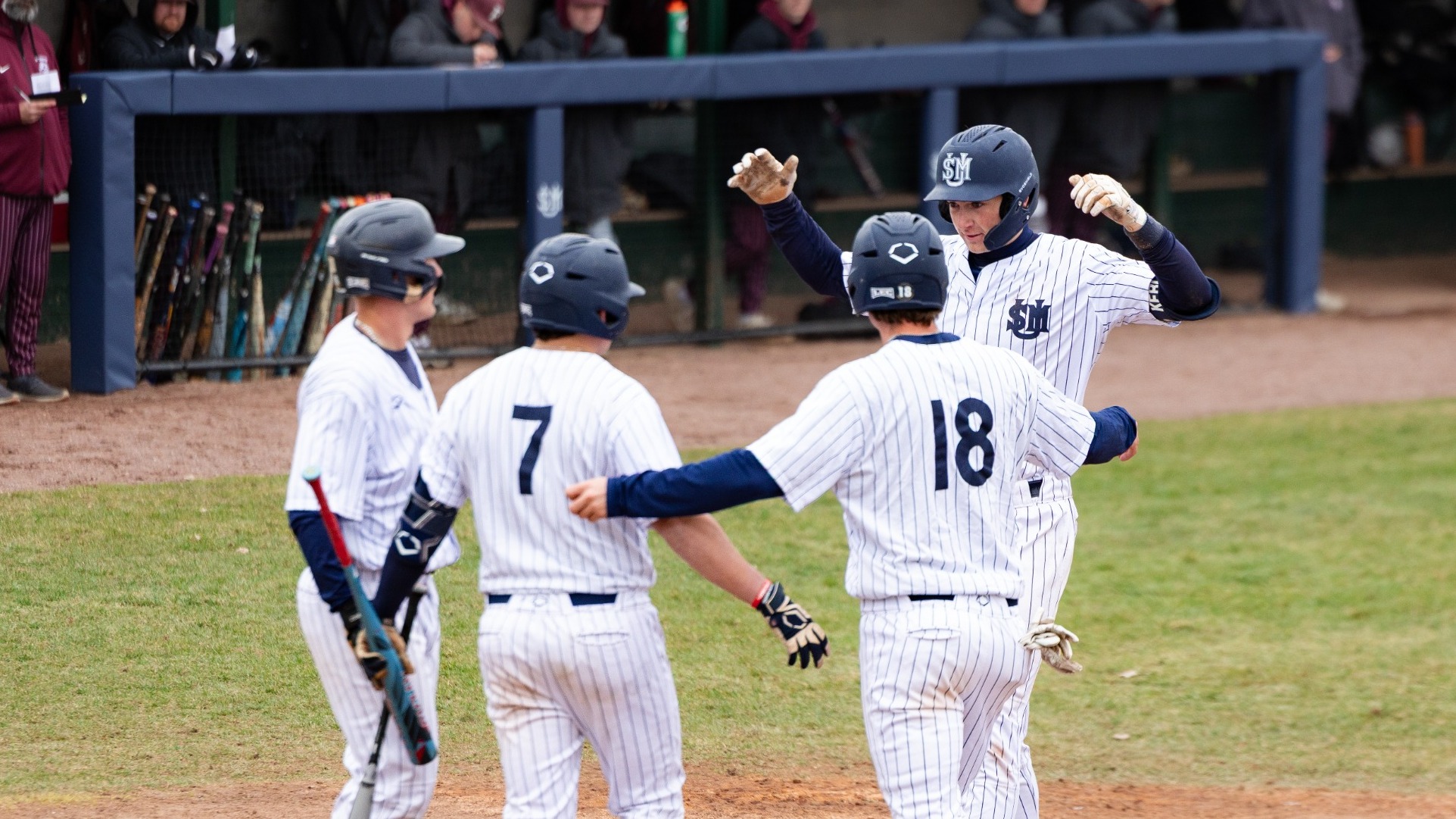Huskies' celebrate at home plate vs UMaine Farmington