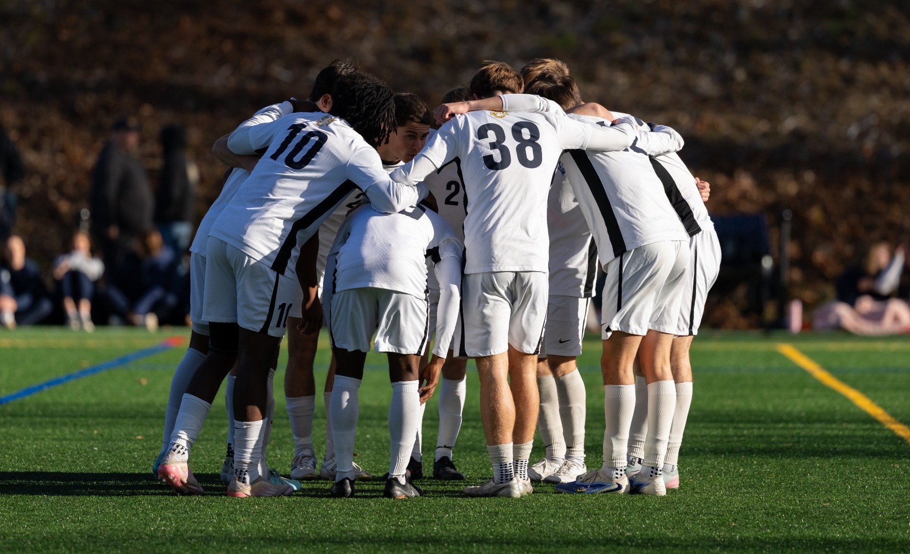 Men's Soccer Starters in huddle prior to game