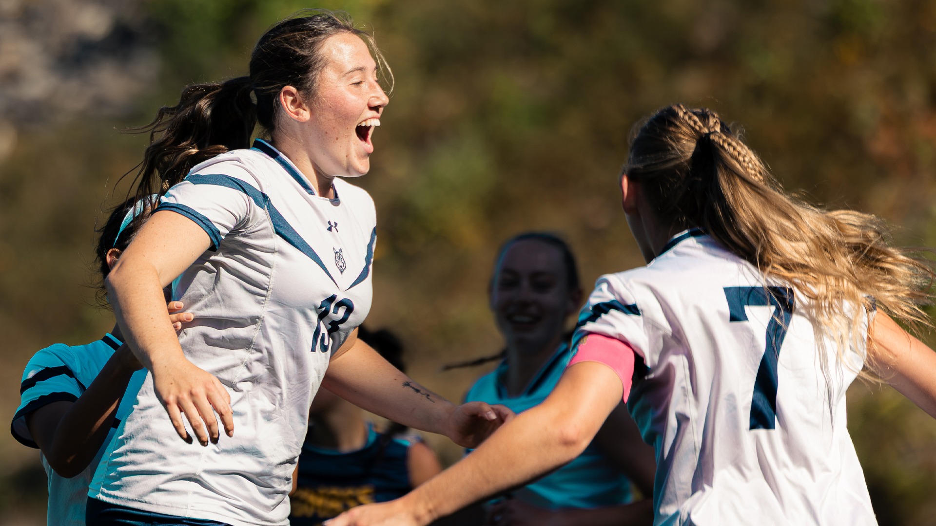Ava Walsh celebrates her first career goal, scoring against UMass Dartmouth