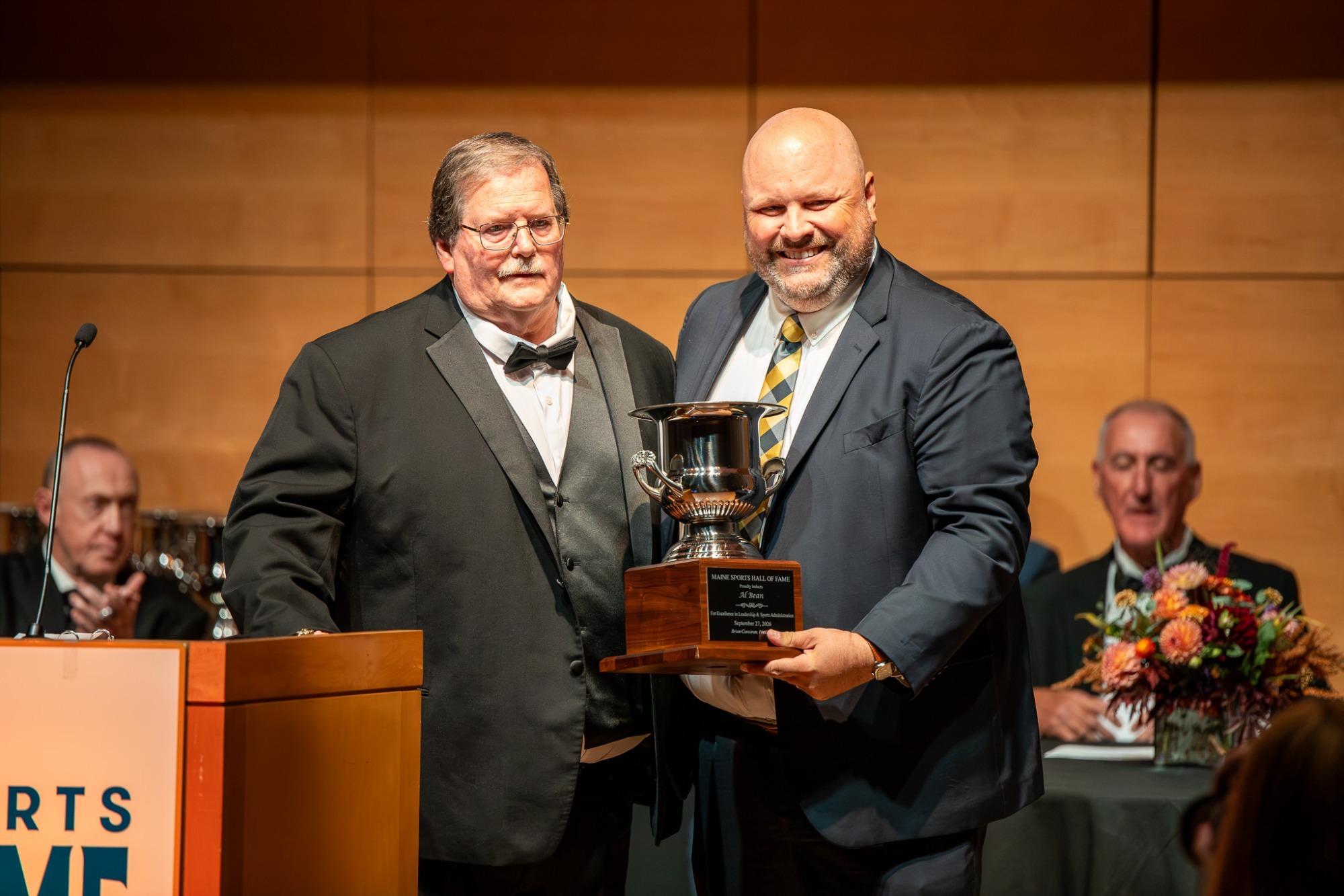 Al Bean receiving Maine State Hall of Fame trophy from current USM Athletic Director John Sutyak