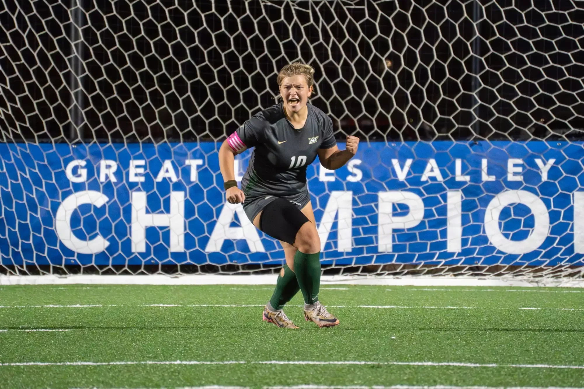 Greycen Erisman of Missouri S&T women's soccer photographed celebrating after a successful PK. She pumps her fist in celebration and yelling and is wearing an all gray uniform
