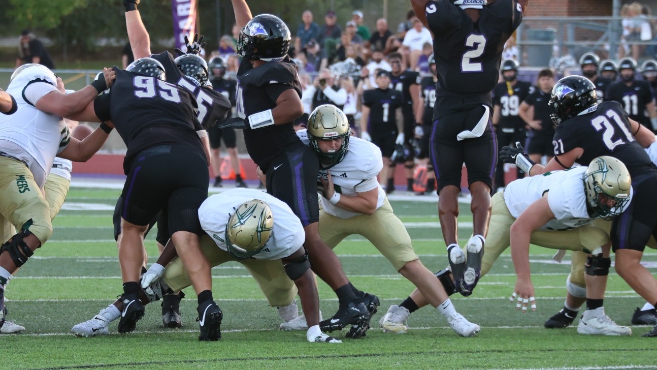 A photo of S&T Football Long Snapper Graham Carter blocking a Southwest Baptist Player during a field goal attempt