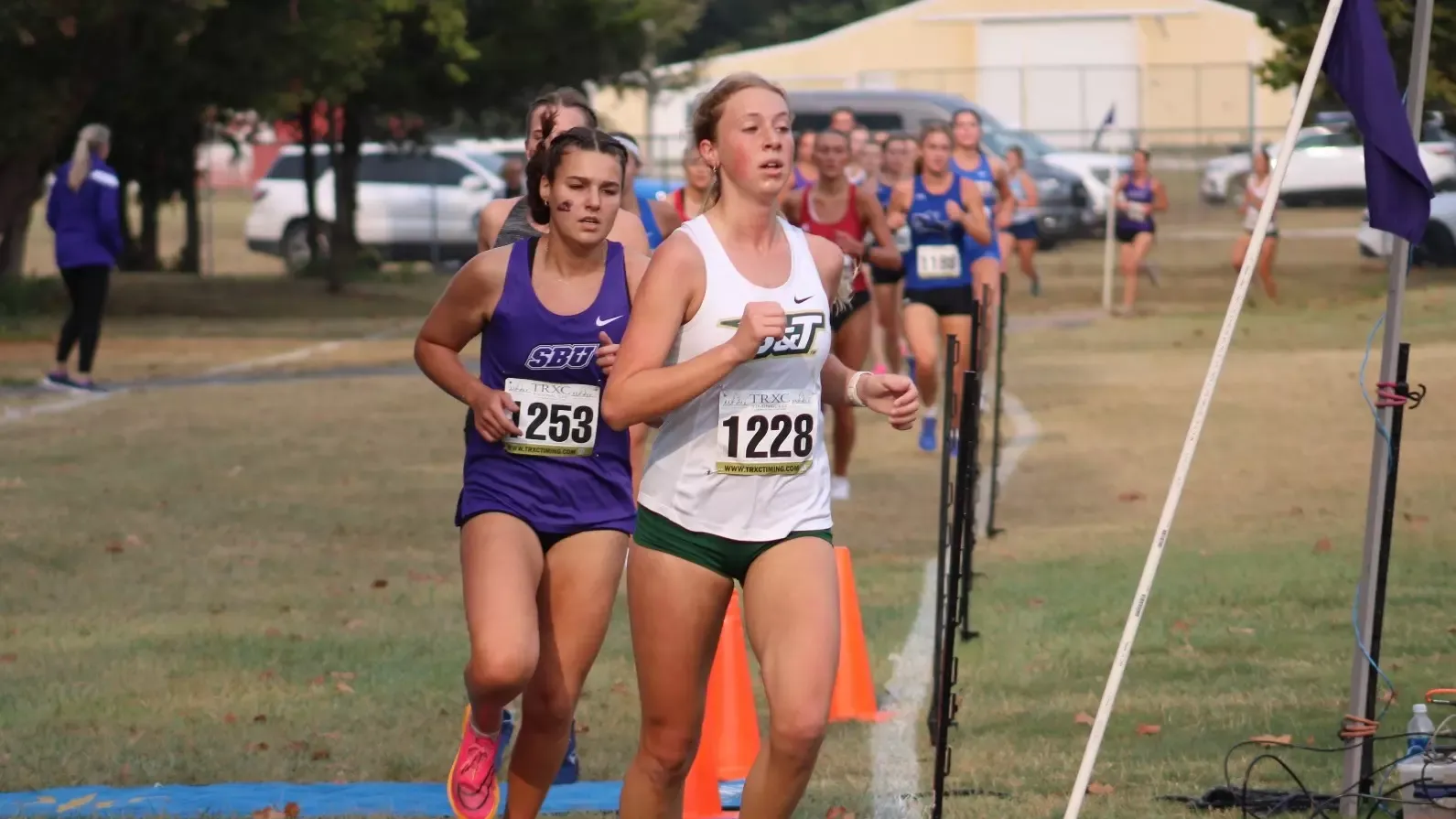 Genna Wacker of Missouri S&T Cross Country photographed running in stride during a meet at the Bearcat Invite