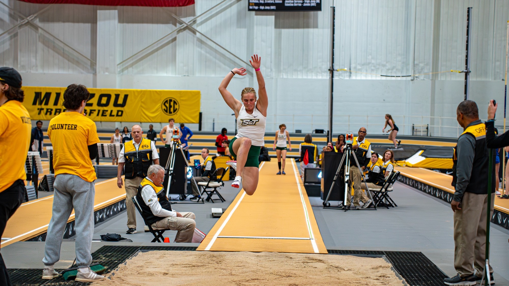 Missouri S&T Maddie Falls mid jump competing in long jump at the Show Me Showdown hosted by Mizzou.