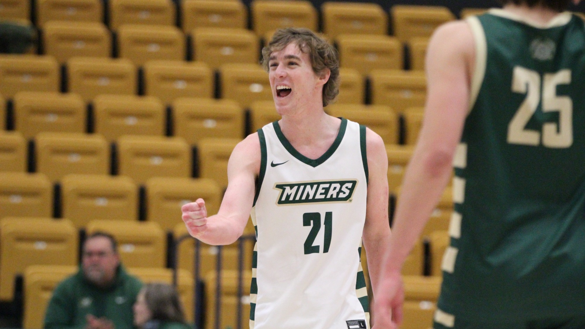 Missouri S&T men's volleyball athlete Grant Edmonds wearing a white jersey and celebrating with a fist pump after a point won