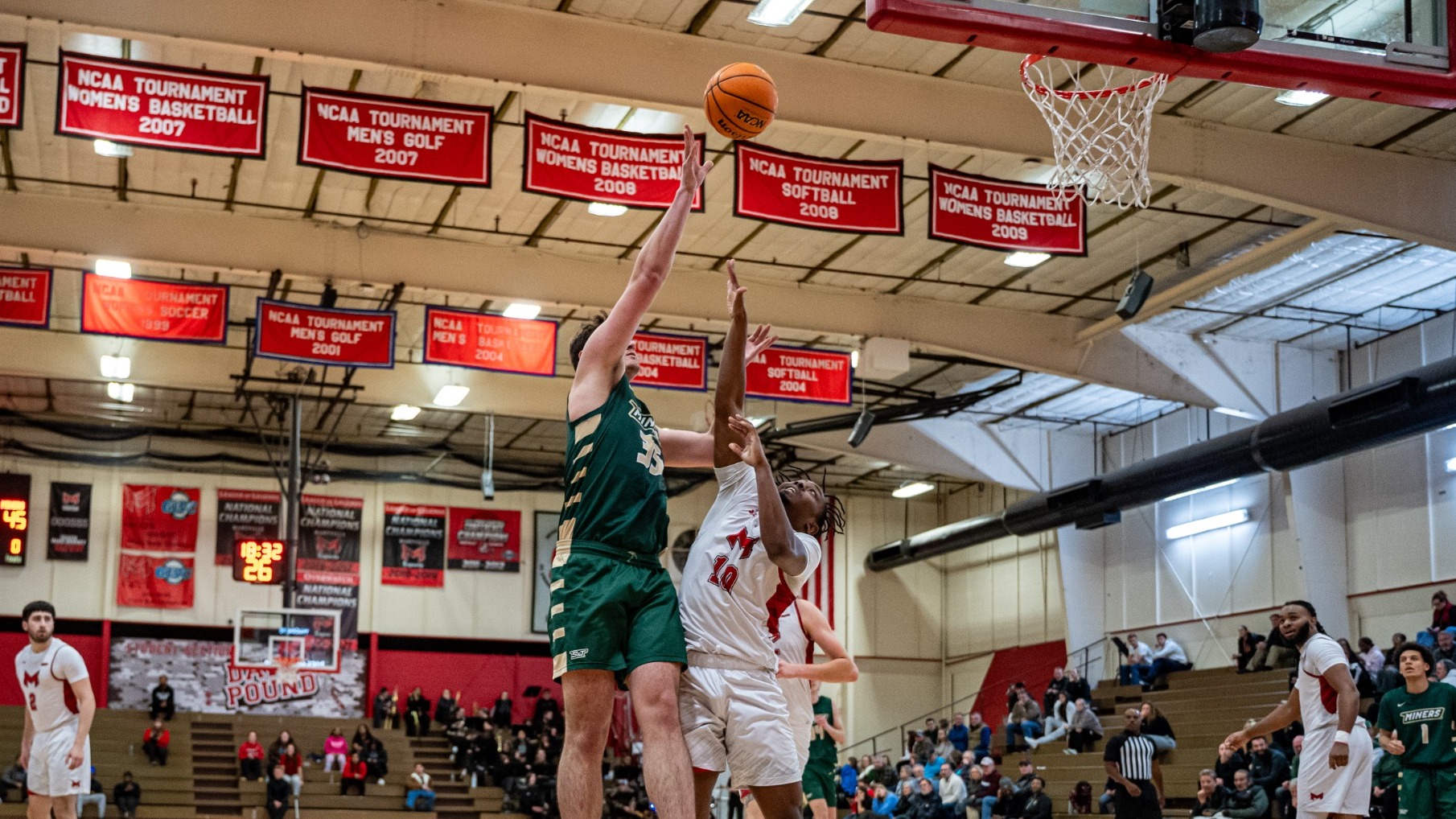 Missouri S&T men's basketball's Zac Brown elevates over a Maryville defender and shoots a shot in the paint during a basketball game at Maryville
