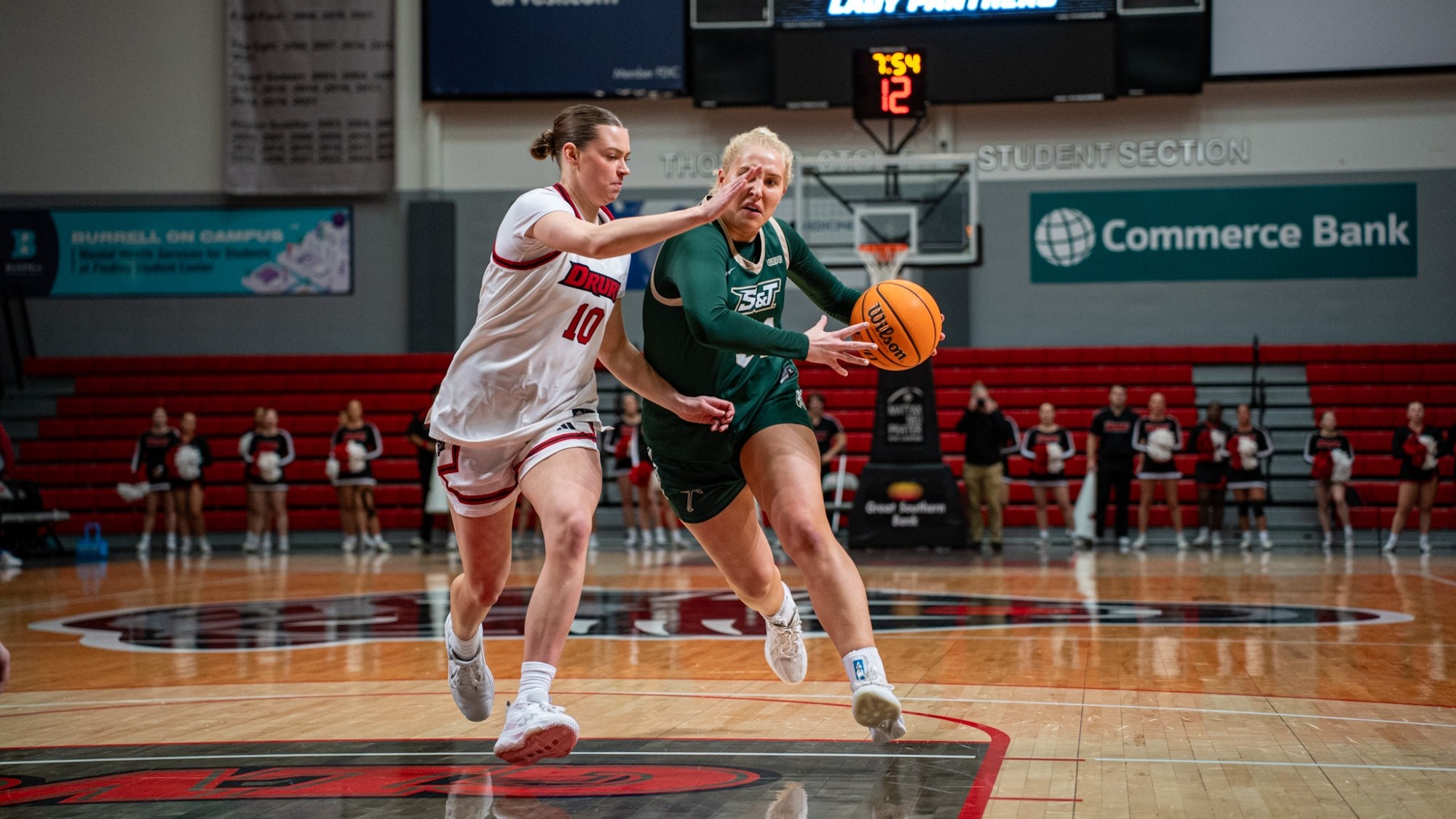 Missouri S&T’s Anna Gilbertson drives through the lane while protecting the ball from a Drury defender during a women’s basketball game at the O’Reilly Family Event Center.