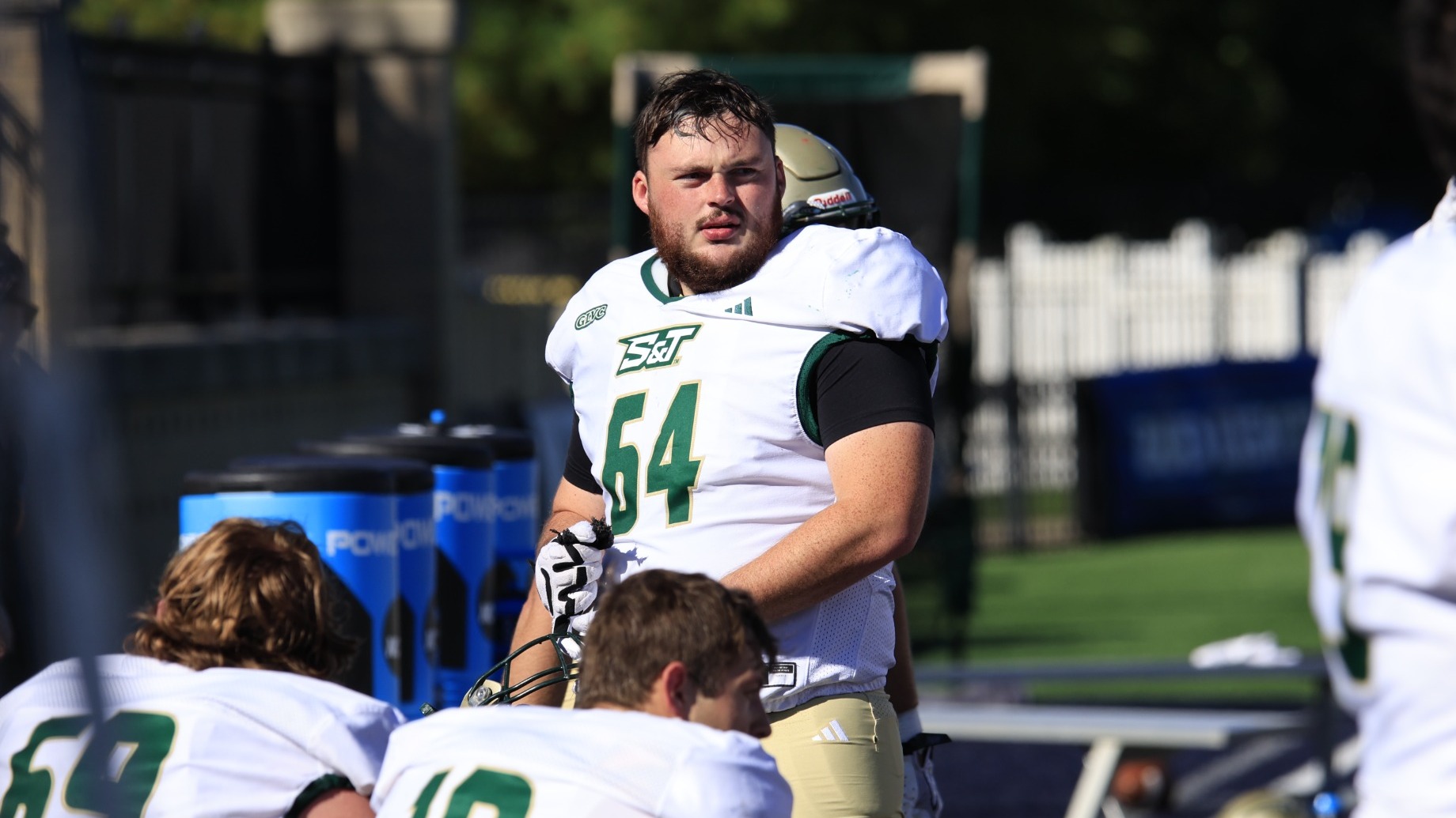 Nick Stiles of Missouri S&T Football photographed on the sideline at Upper Iowa wearing a white uniform and football pads