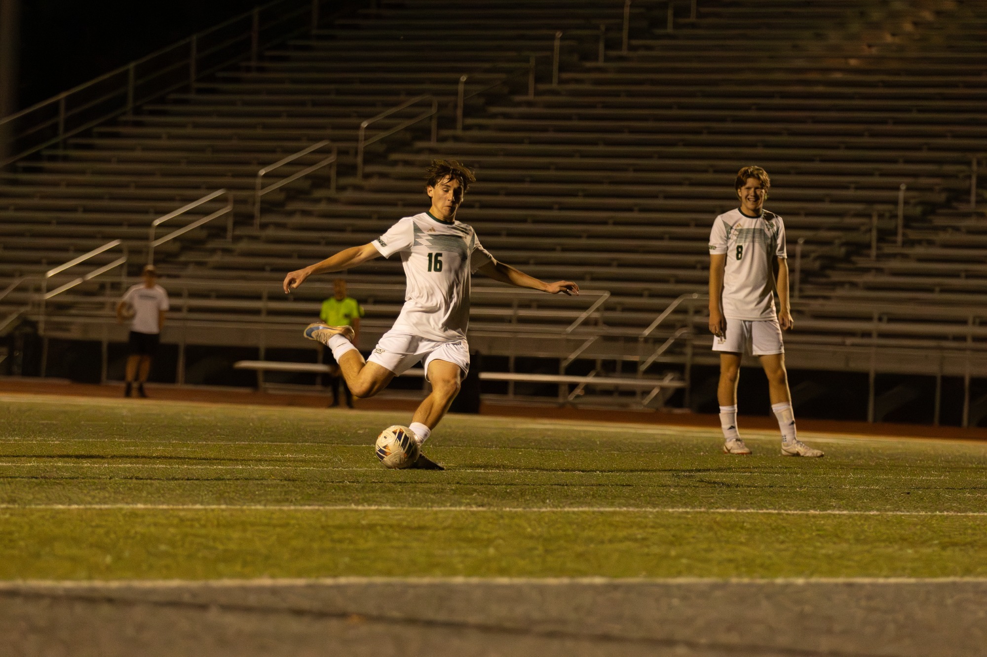 Ian Connor drawing his leg back for a penalty kick. He is wearing a white jersey and white shorts. 