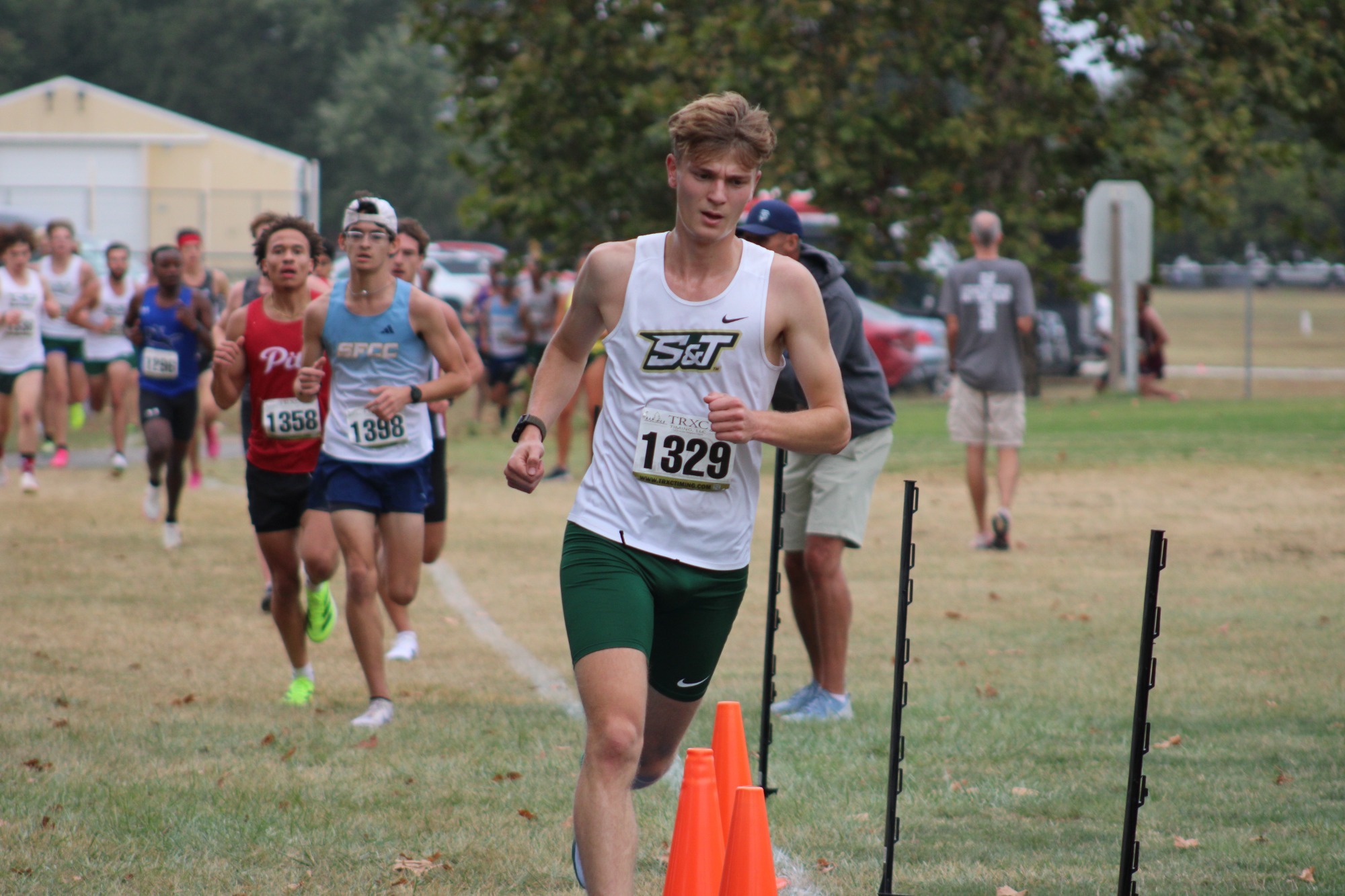 Aiden Kerns running on a grass cross country track