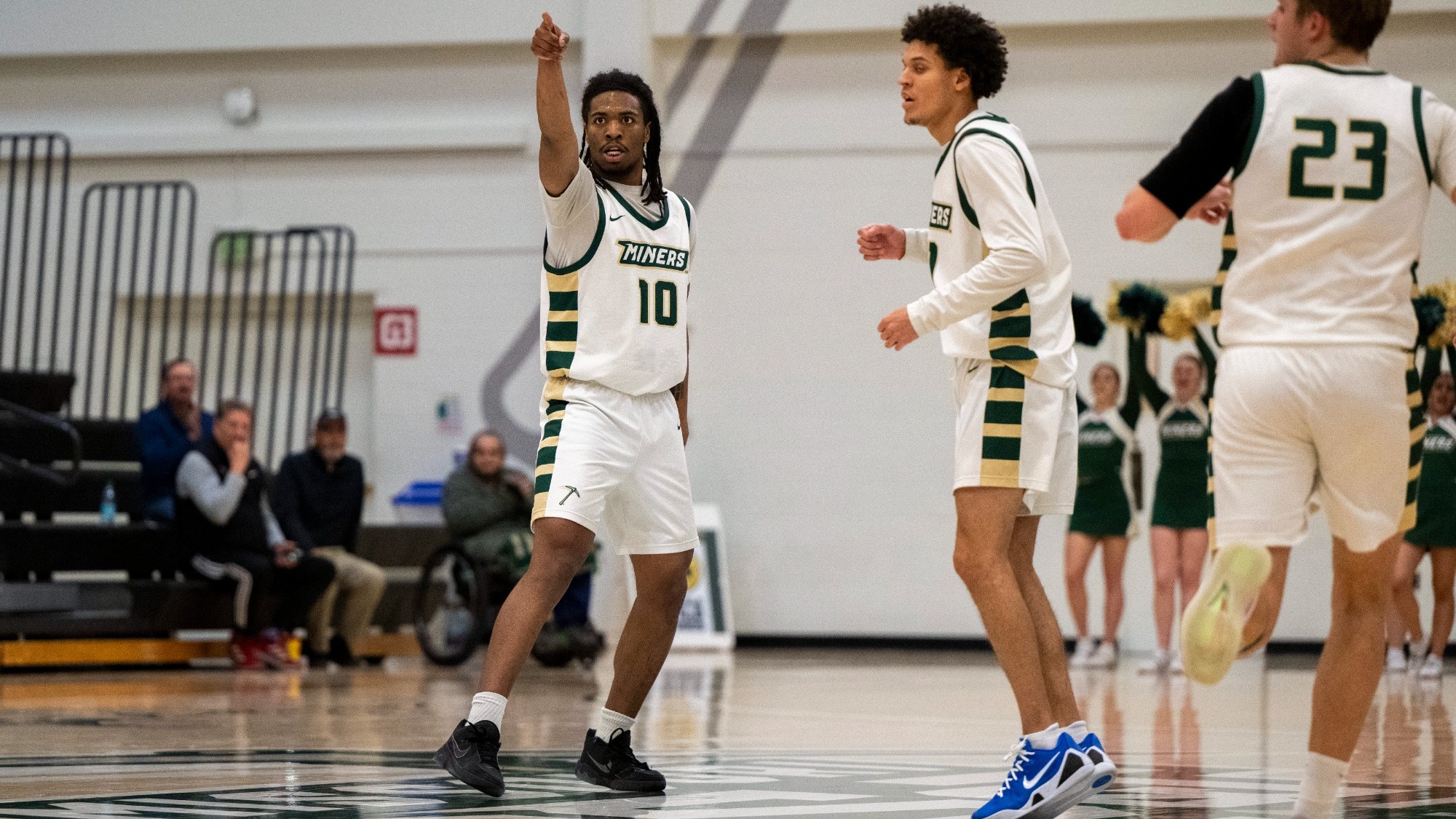 Cam Stovall of Missouri S&T photographed wearing a white uniform and pointing after making a three-pointer during a match in Gibson Arena