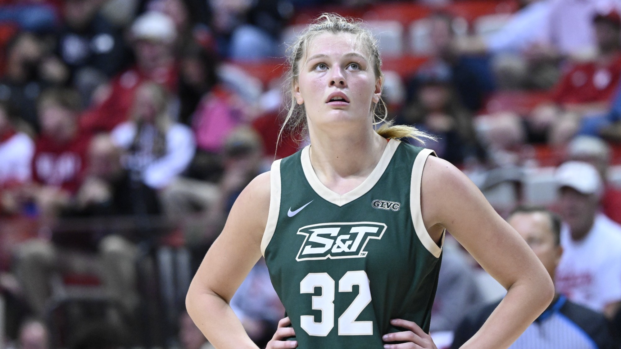 Ava McCulla in a green jersey with a white 32 on the front looking up at the scoreboard with her mouth slightly open 