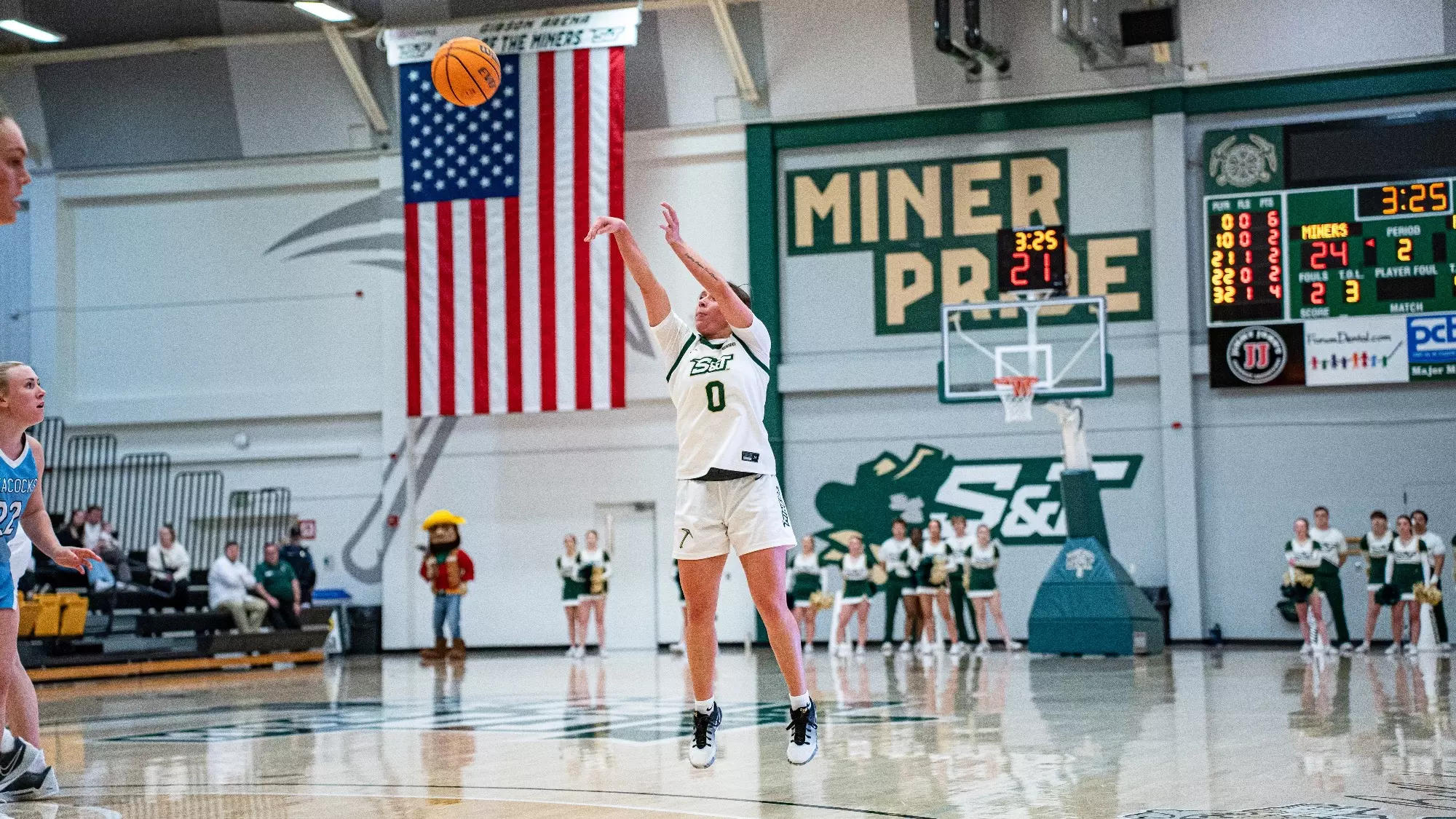 Missouri S&T basketball player Macy Marraccini in a white S&T jersey shooting a three pointer in Gibson Arena.