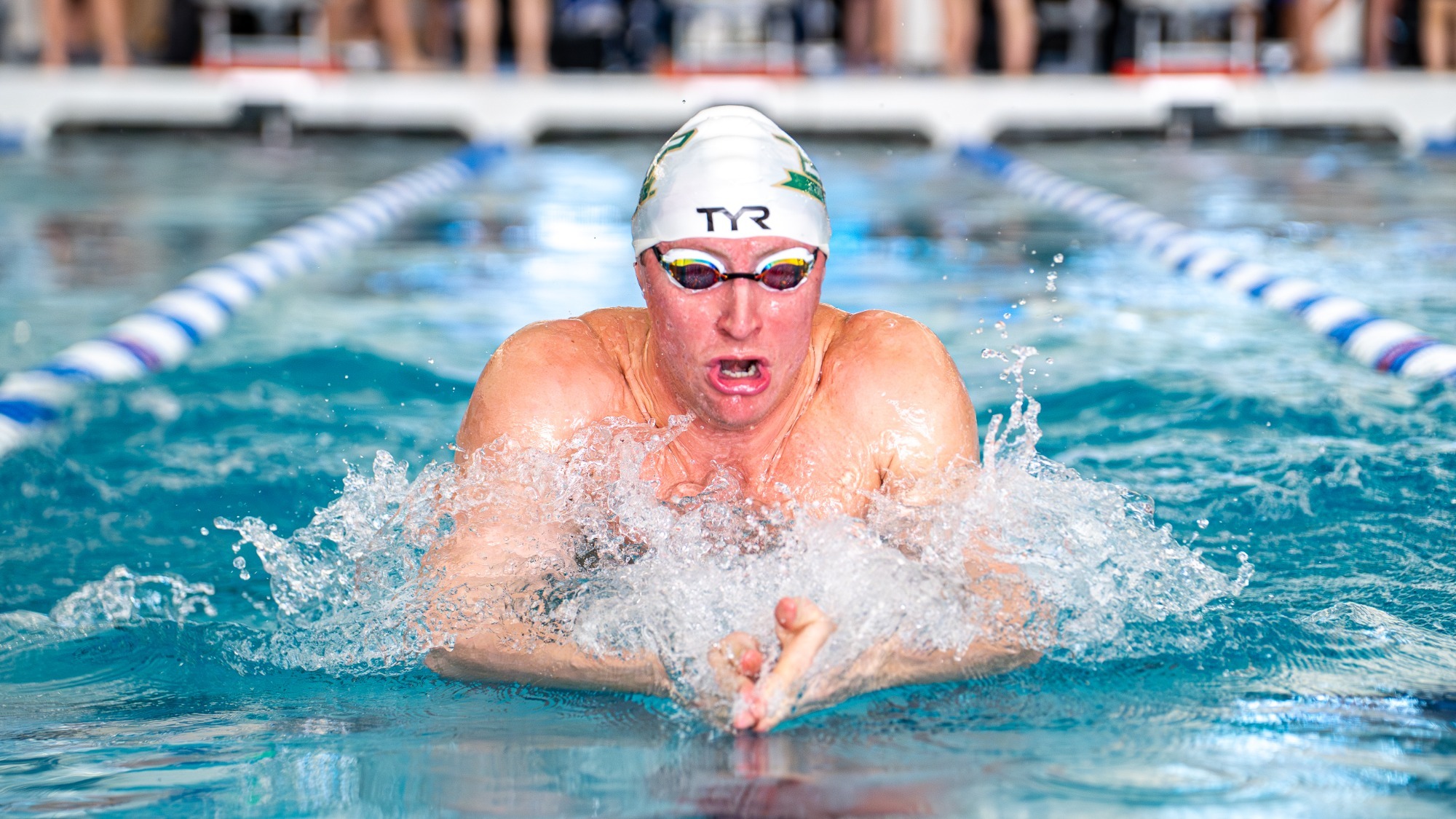 Missouri S&T swimmer Jordan Christensen emerging from the water during the breastroke at the GLVC championships