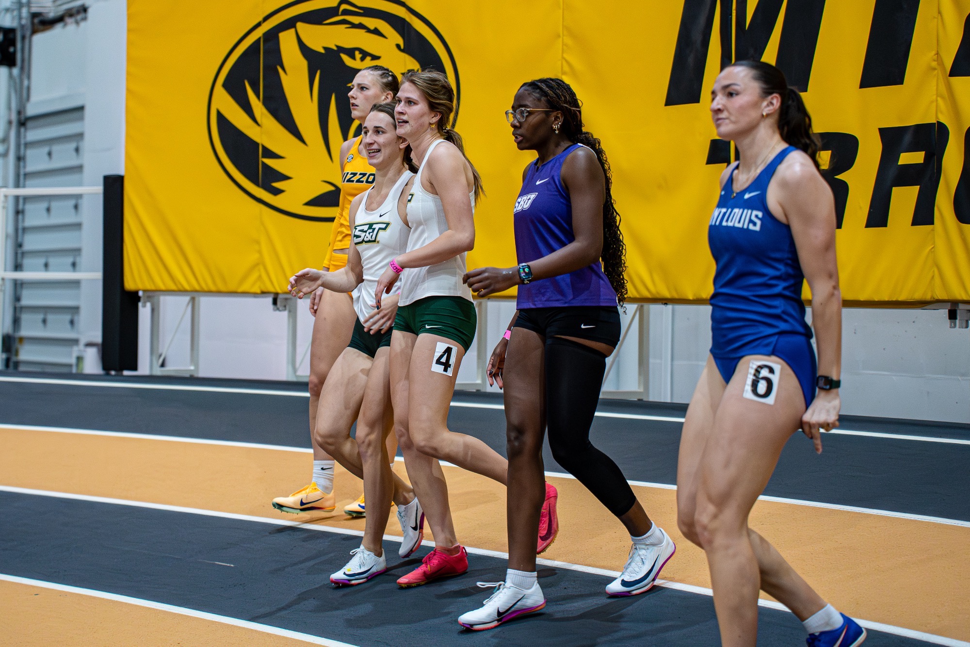 Missouri S&T women's track and field athletes Mary Kimmerle & Maya Wright hugging after crossing the finish line at the Show Me Showdown.