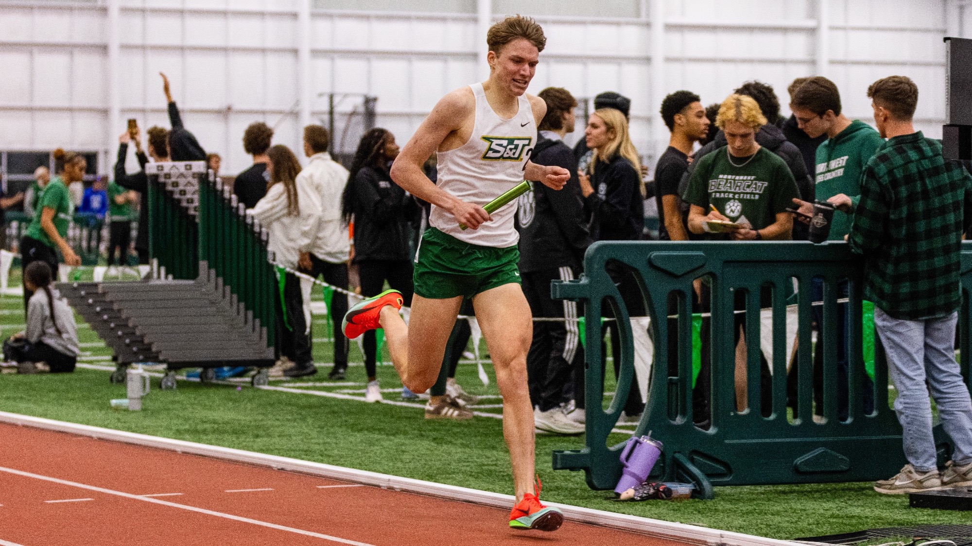 Missouri S&T distance runner Henry Born getting ready to cross the finish line at a track meet while competing in the 4,000m distance Medley Relay.
