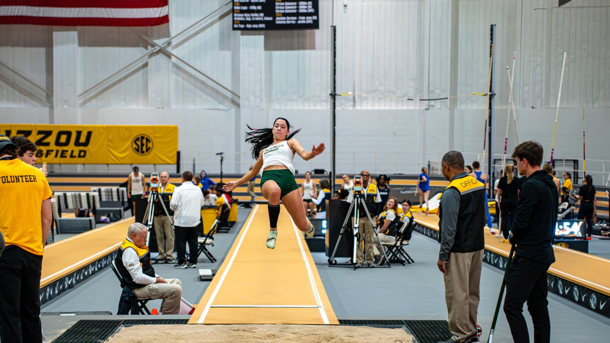 Missouri S&T long jumper Lauryn Fenoglio soars through the air during her attempt in the long jump at the Show Me Showdown, hosted by Mizzou, inside an indoor track facility.