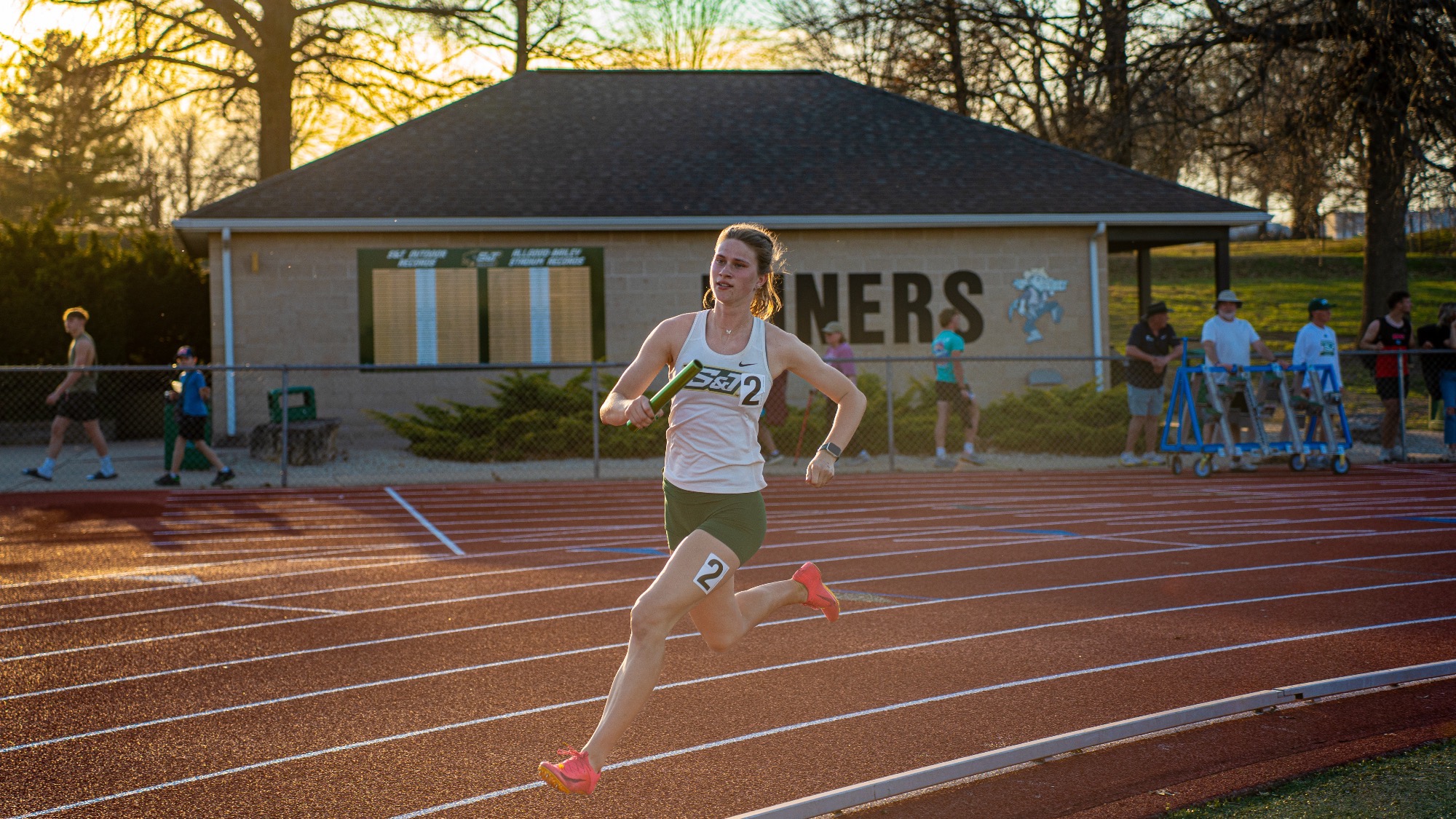 Missouri S&T’s Maya Wright sprints the anchor leg of the 4x400-meter relay on the track at Allgood-Bailey Stadium, driving toward the finish as the sun sets, helping the Miners to a second-place finish.