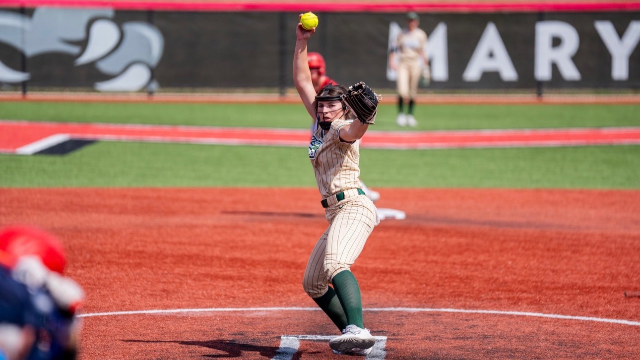 Missouri S&T softball pitcher delivers a pitch from the circle in a gold Miners jersey during a road game at Maryville University in Chesterfield, Missouri.